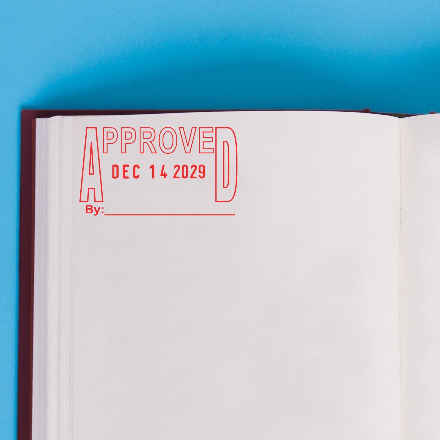Open book page with red approved stamp and date Dec 14 2029 on a blue background.