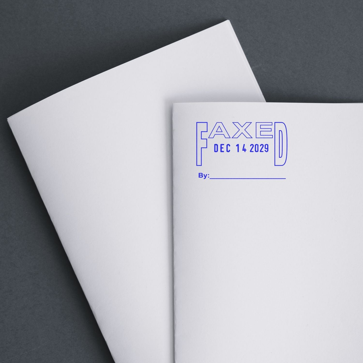 Blank faxed document cover with FAXED Dec 14 2029 text on white paper folders against a dark background.