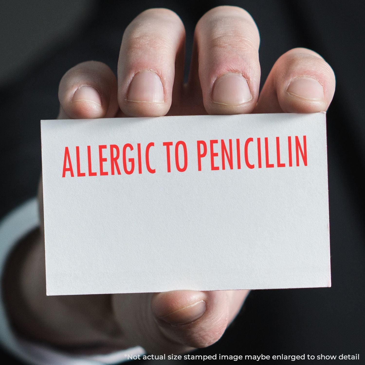 Close-up of a hand holding a card that says 'Allergic to Penicillin'a medication safety alert for patients and clinicians.