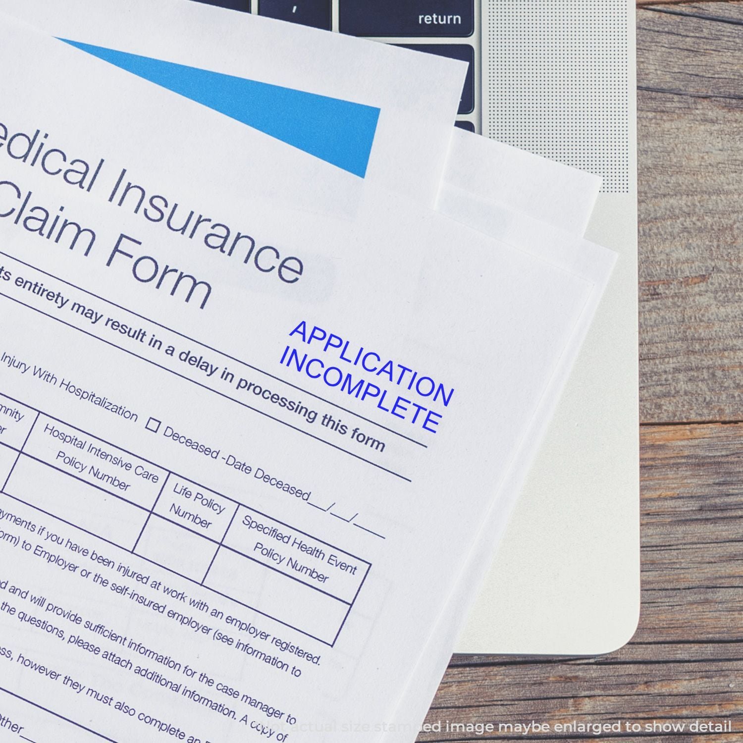 Incomplete medical insurance claim form on a laptop keyboard, health insurance paperwork marked application incomplete.