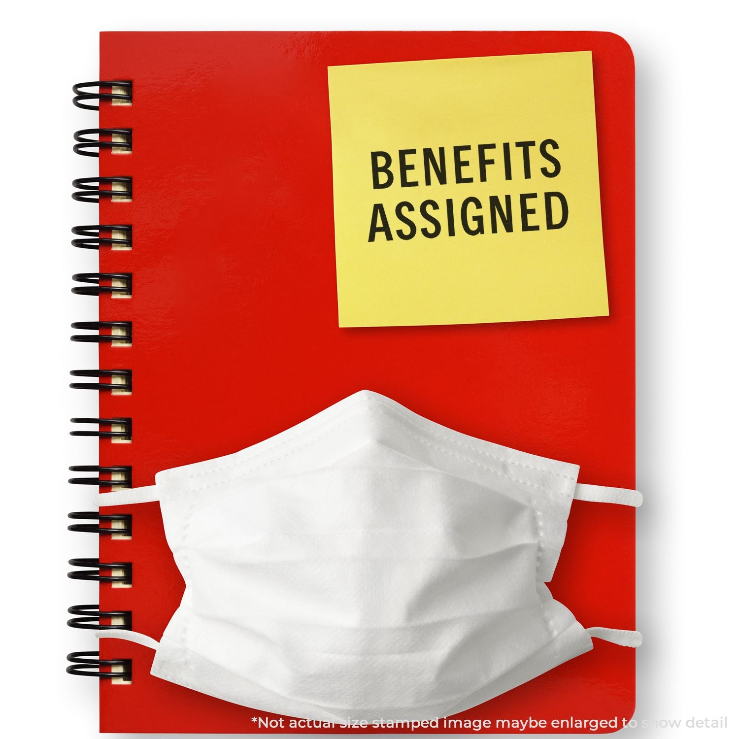 Red notebook with Benefits Assigned sticky note and white face mask, symbolizing employee benefits and healthcare planning.