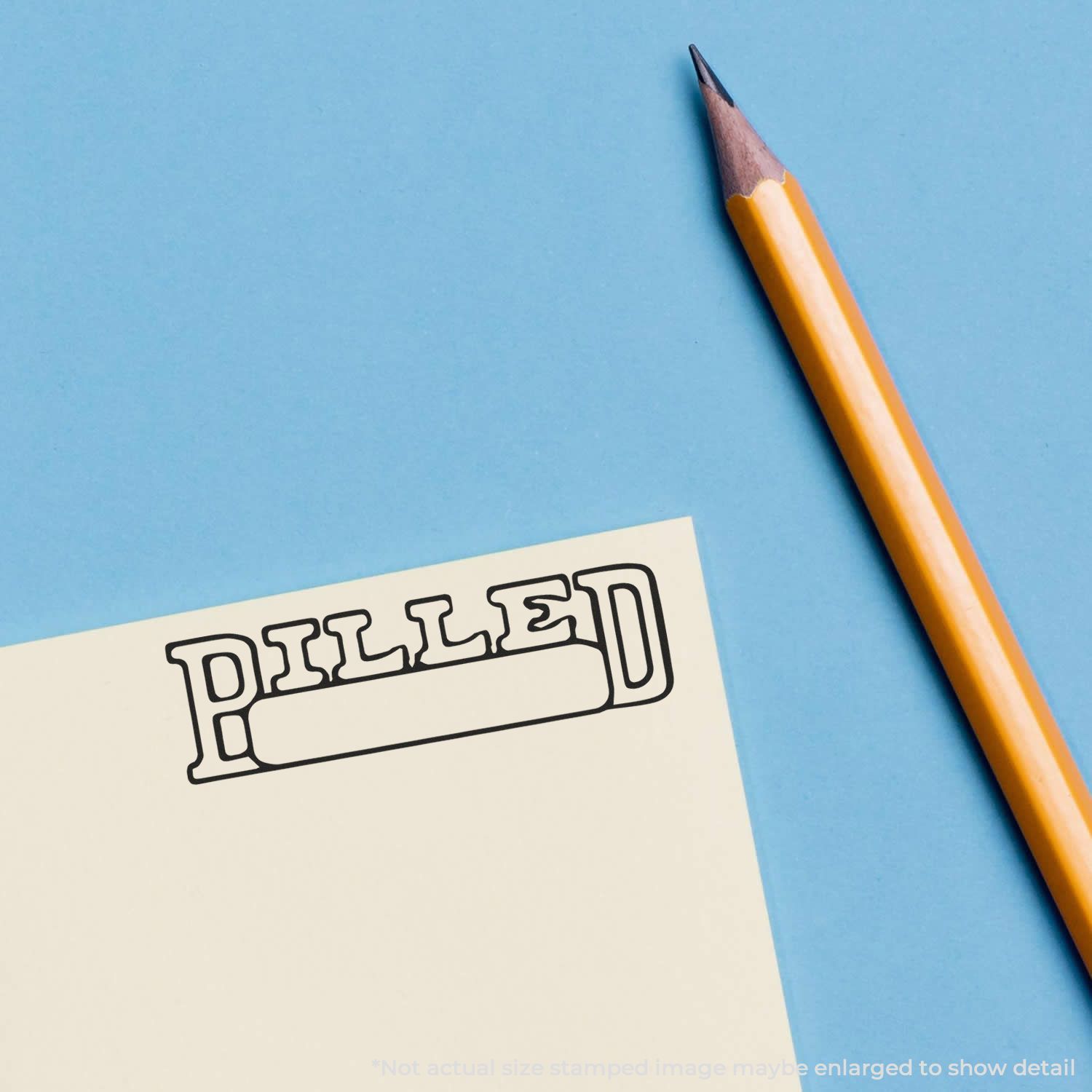 Yellow pencil beside paper with PILLED stamp illustration on a blue background.