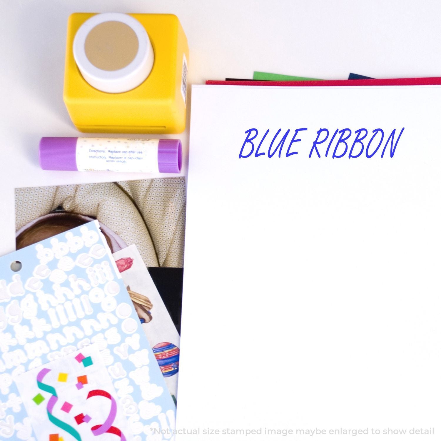 Blue Ribbon craft suppliesyellow stamp, purple ink tube, and paper for youth school projects and ribbon education.