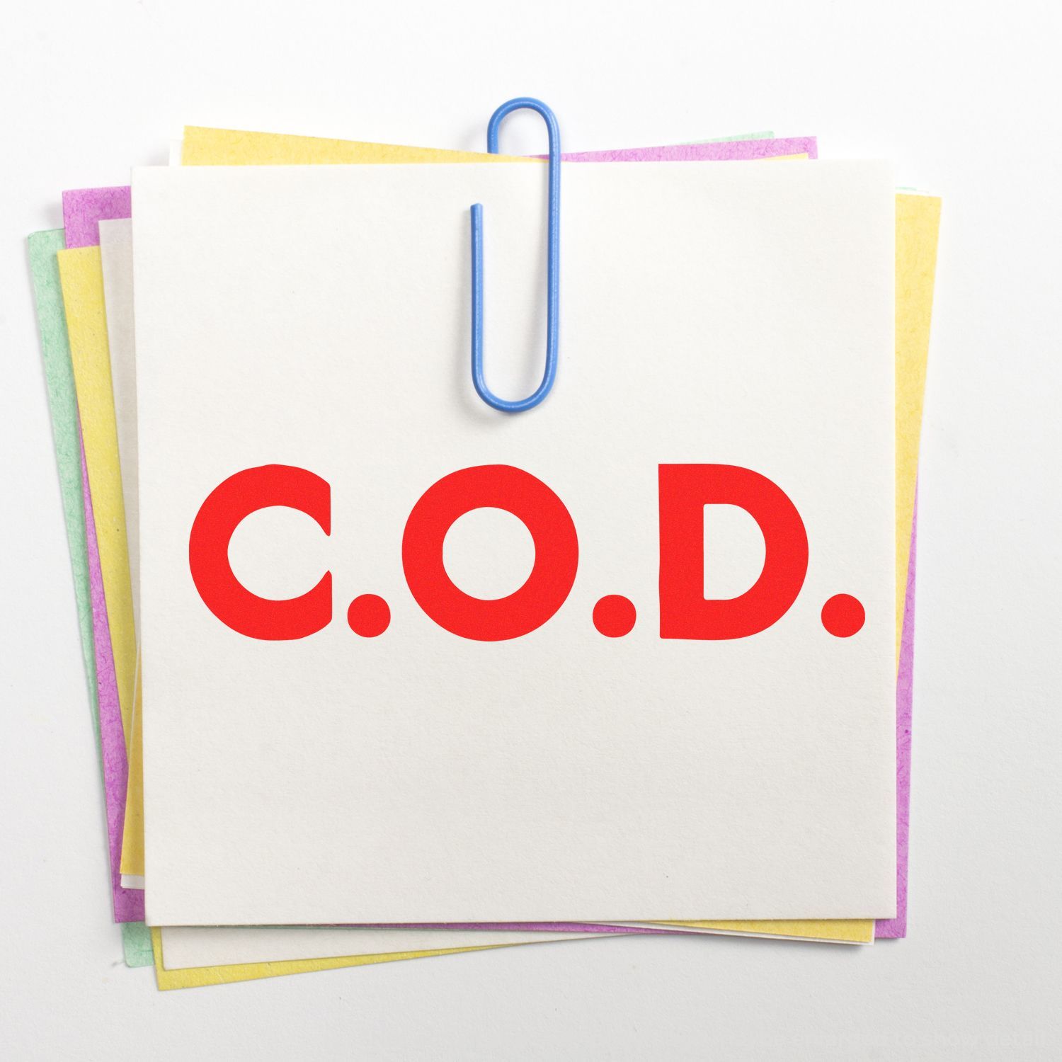 Stack of shopping paper bags labeled C.O.D. for cash on delivery, with blue handle and colorful background.