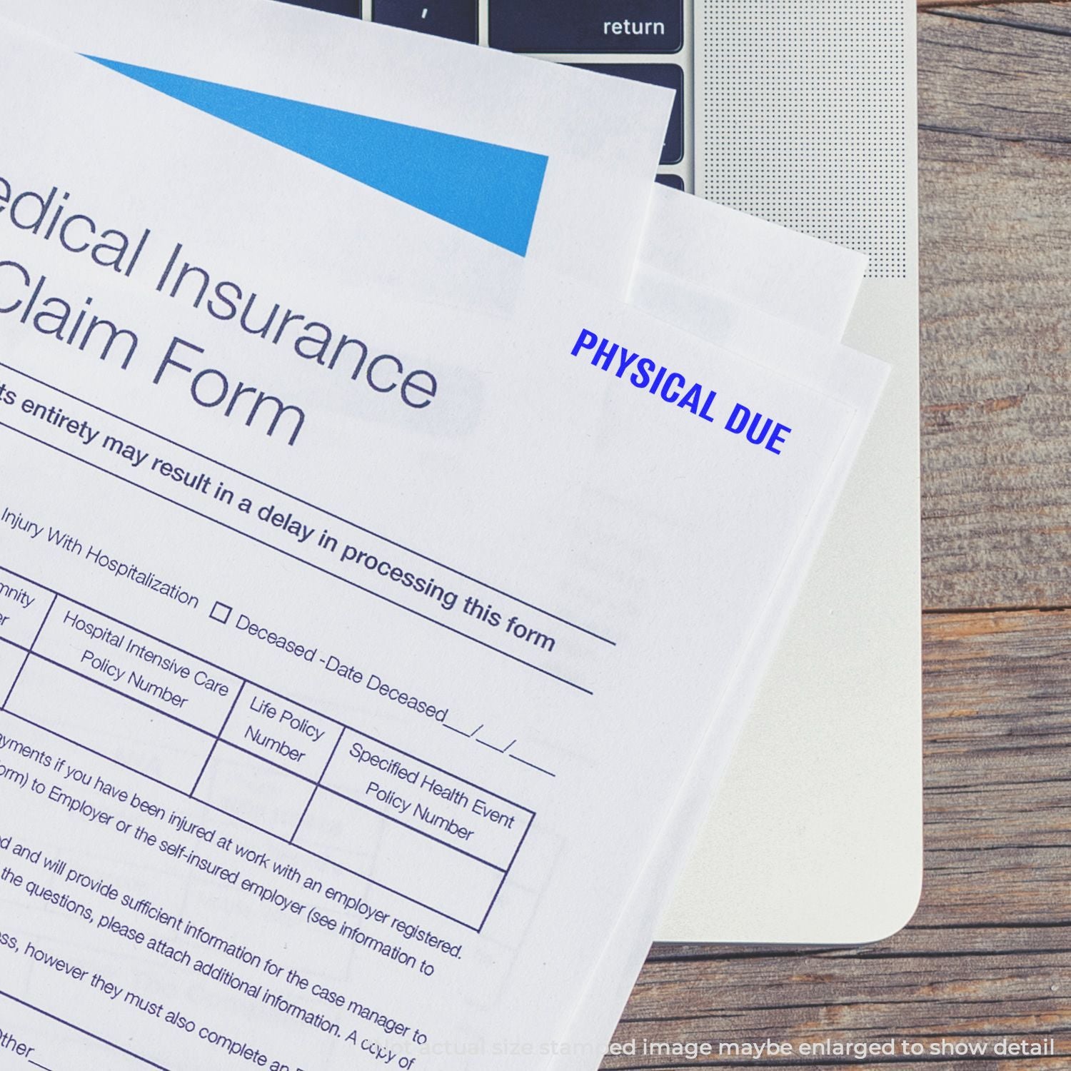 Medical insurance claim form labeled Physical Due on a laptop keyboard, representing healthcare billing and insurance paperwork.