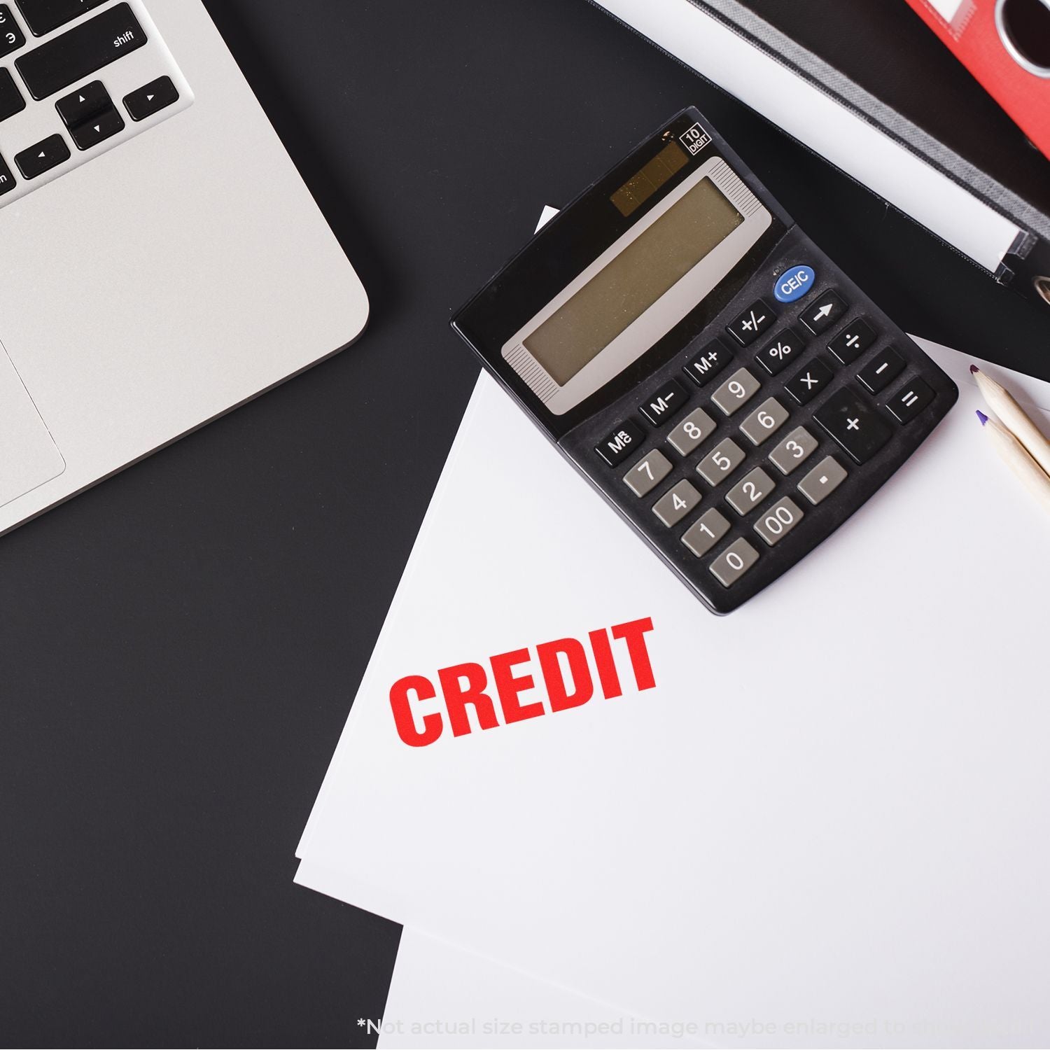 Calculator beside a document stamped CREDIT, illustrating budgeting, credit approval, and financial planning for loans and payments.