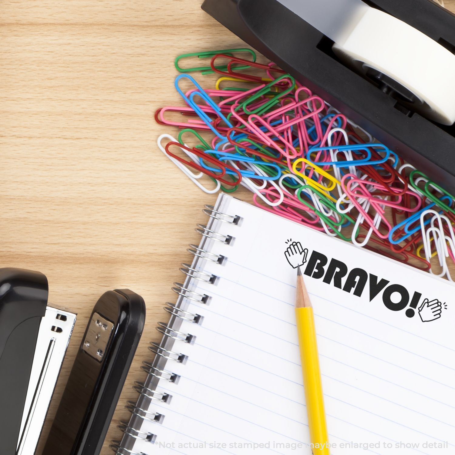 Colorful paper clips scattered on notebook with pencil, back-to-school stationery for organizing school and office.