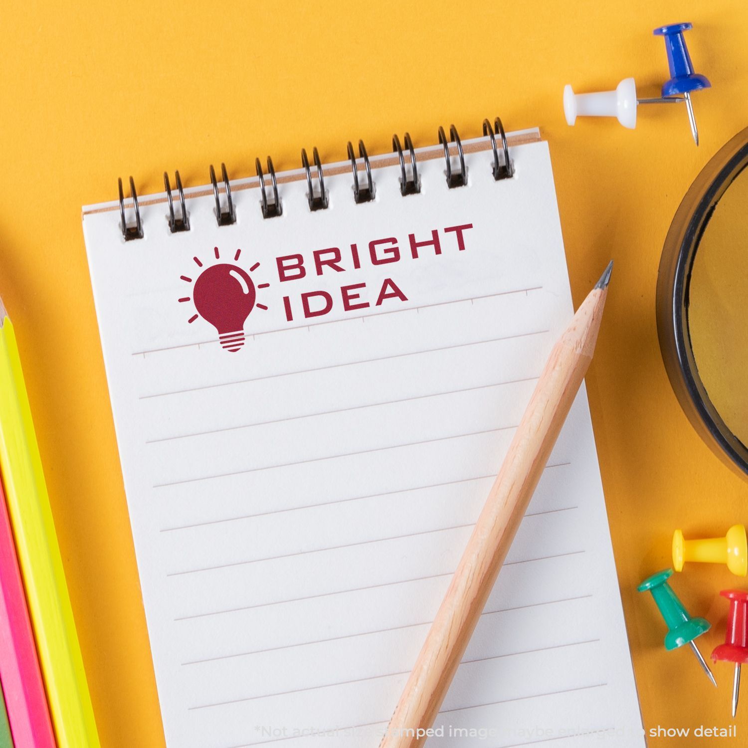 Close-up of a Bright Idea notepad with lightbulb logo, pencil and push pinsideal for creativity, inspiration, and business planning concepts.