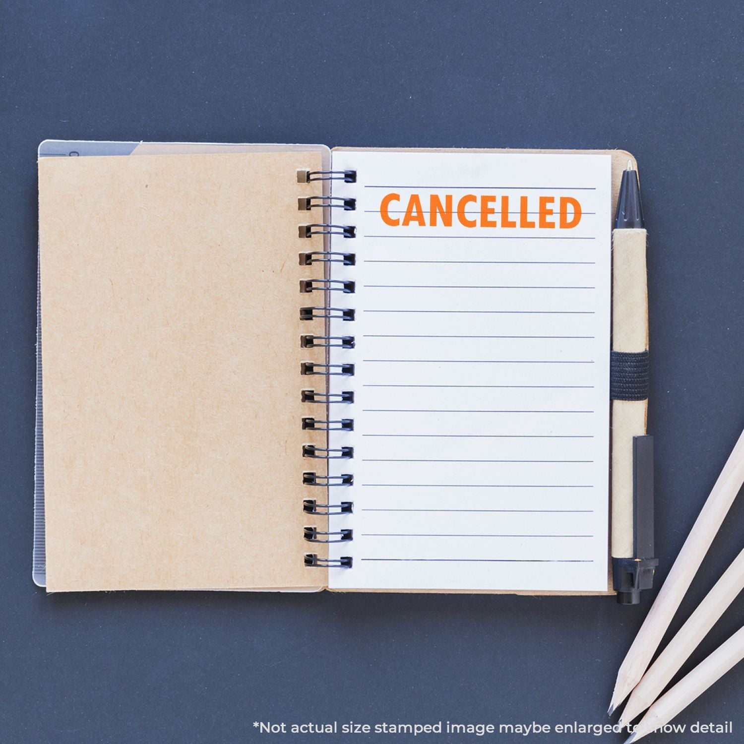 Open planner notebook with CANCELLED stamp, showing appointment or order cancellation and documentation.