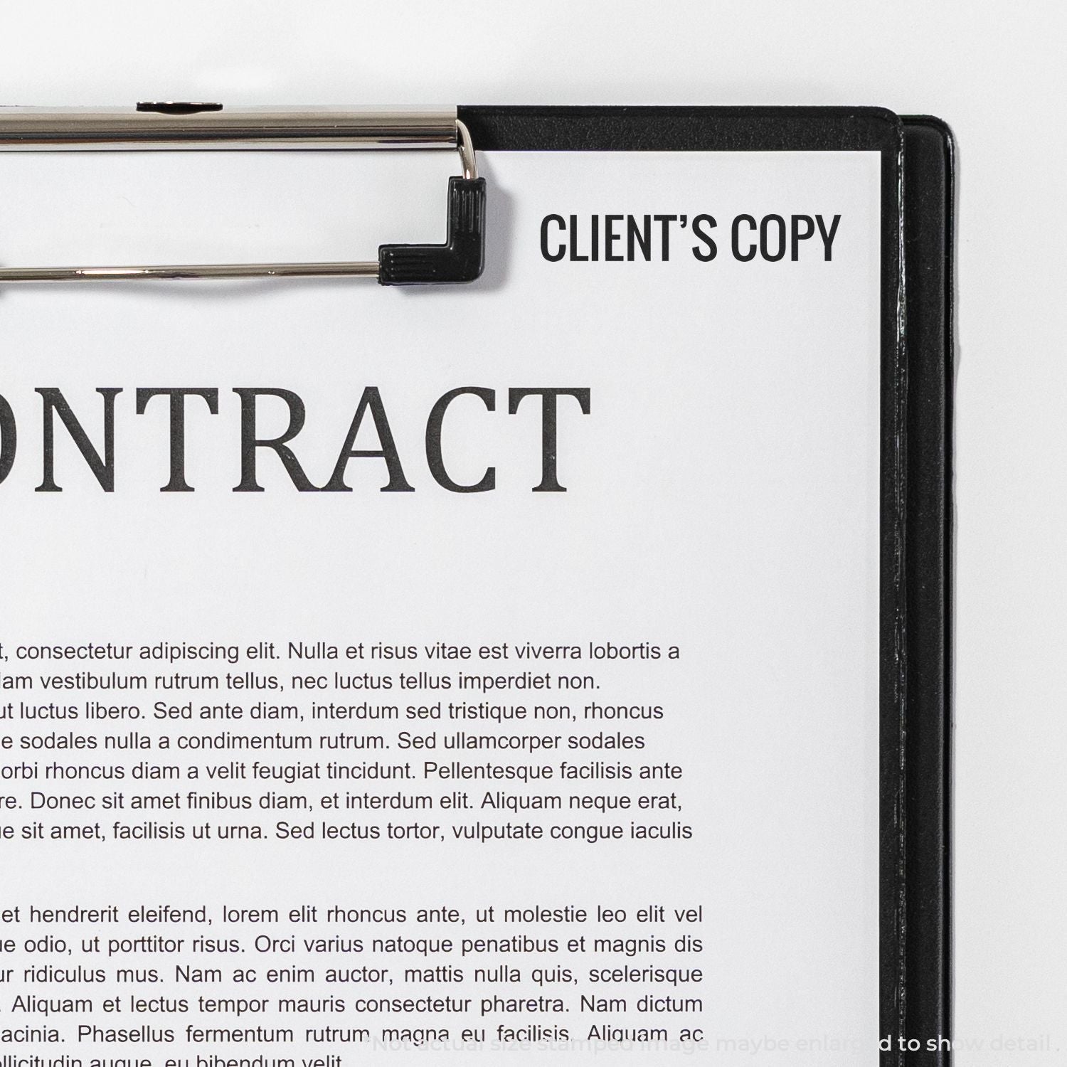 Clipboard holding a contract document labeled Clients Copy for client review and legal agreement.