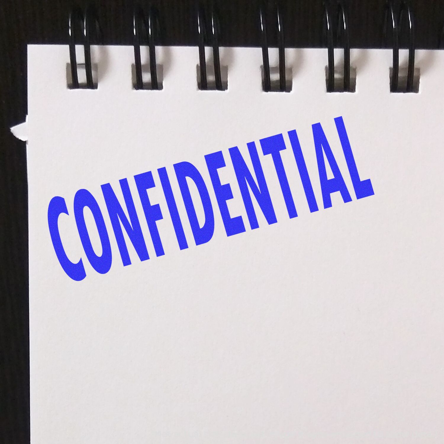 Confidential document folder with metal binder rings, marked CONFIDENTIAL for secure handling and privacy.