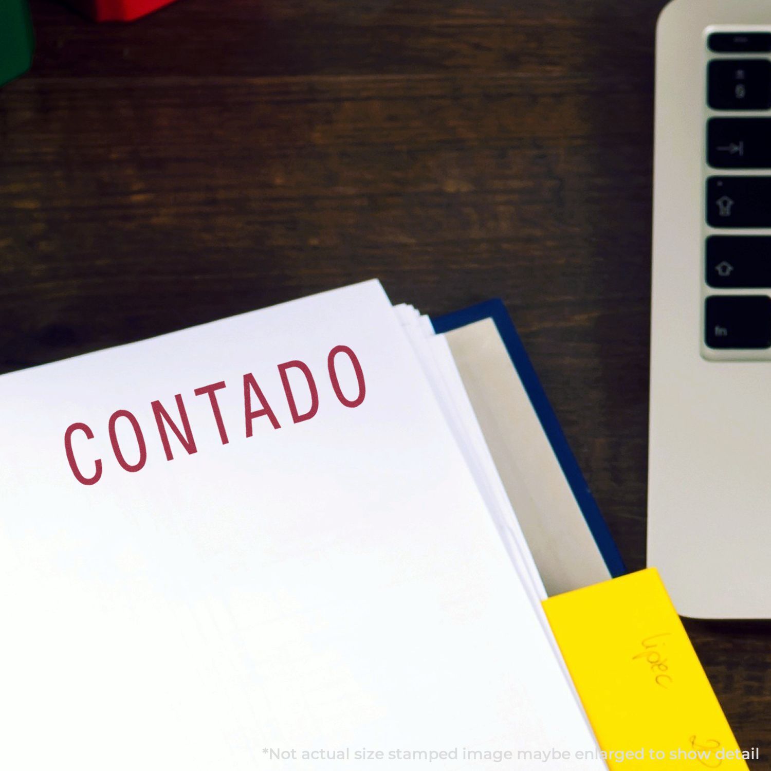 Contado financial documents folder on a desk beside a laptop and sticky notes for accounting and bookkeeping organization