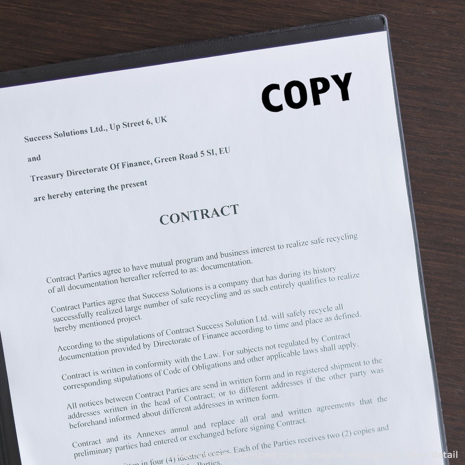 Copy of recycling contract document on a desk, showing CONTRACT title and parties for safe recycling compliance.