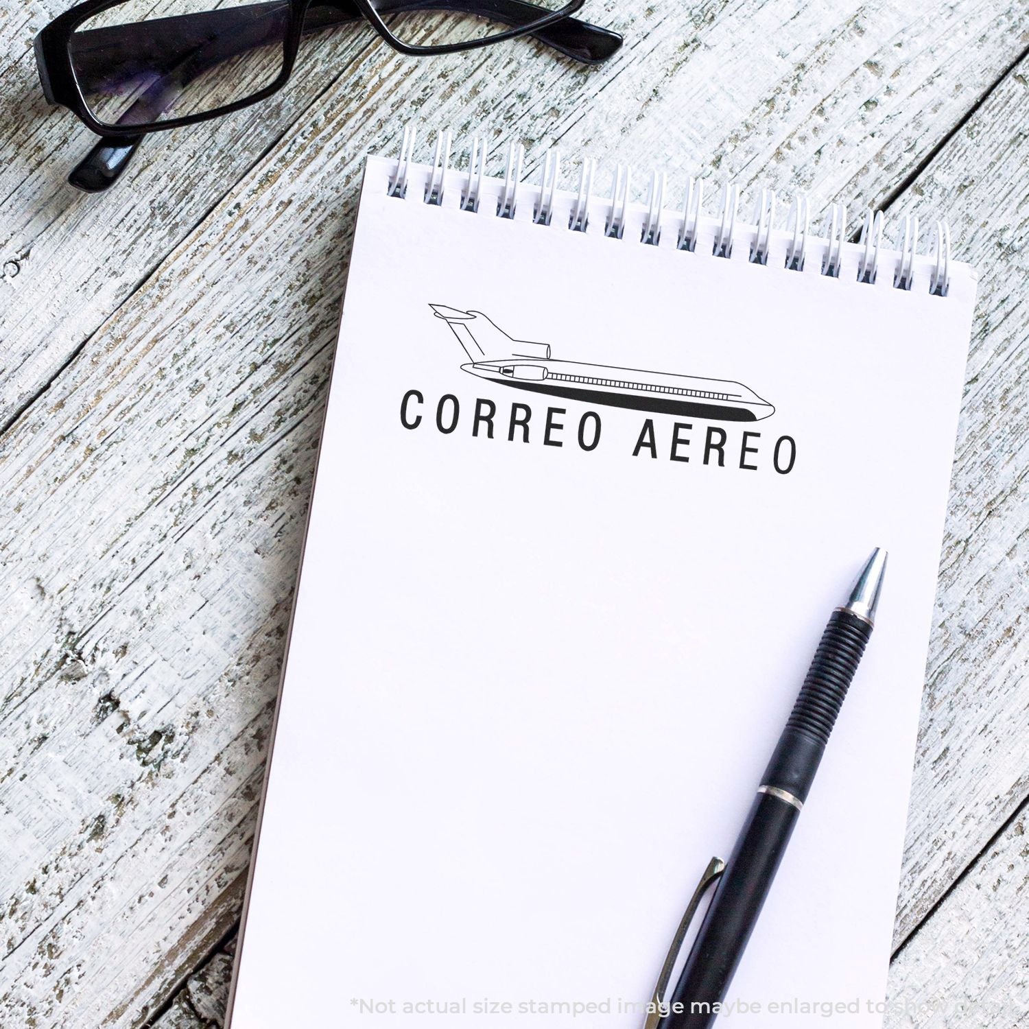 Air mail notebook labeled CORREO AEREO with airplane logo and pen, representing international shipping by air.