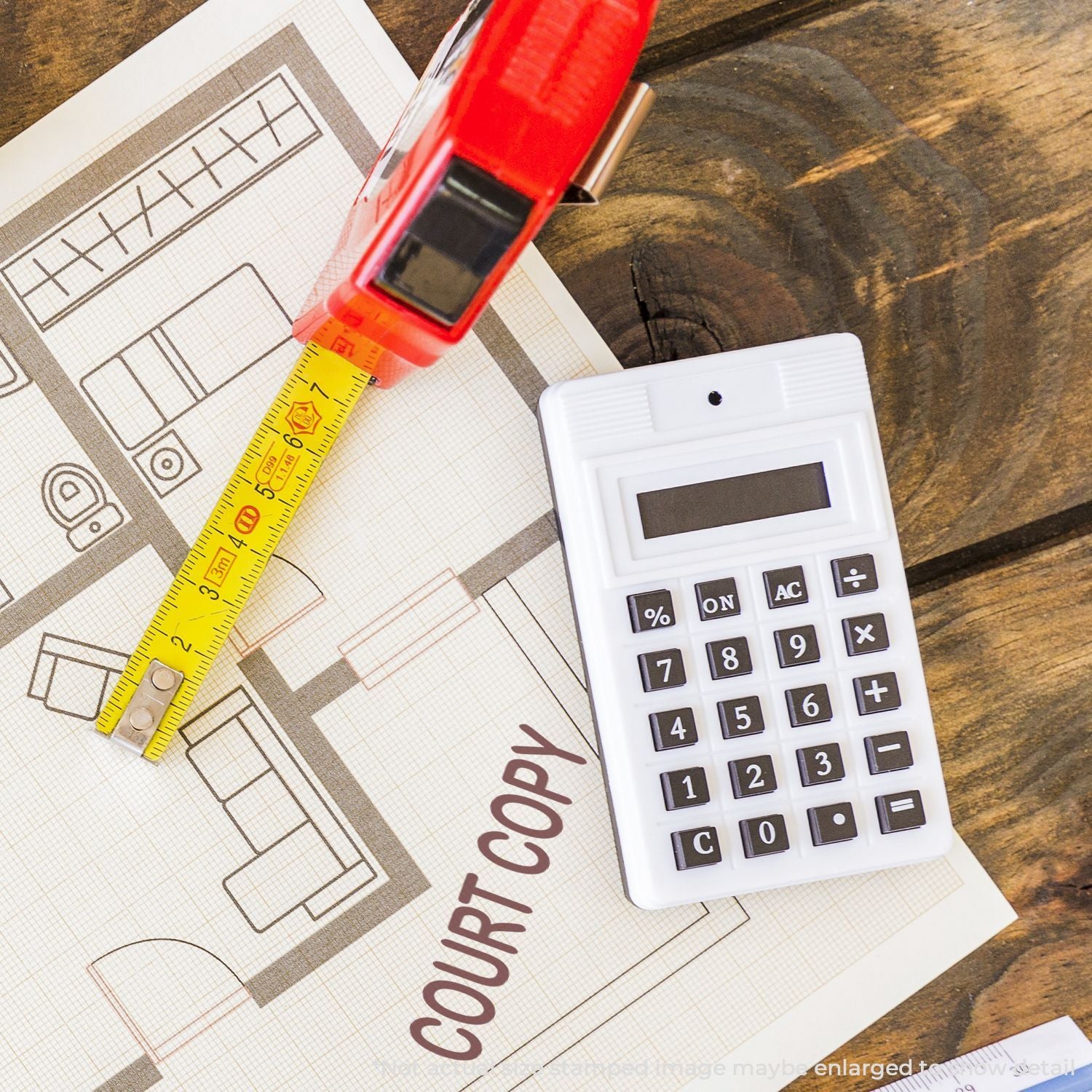 Tape measure and calculator on house floor plan for home renovation cost estimation