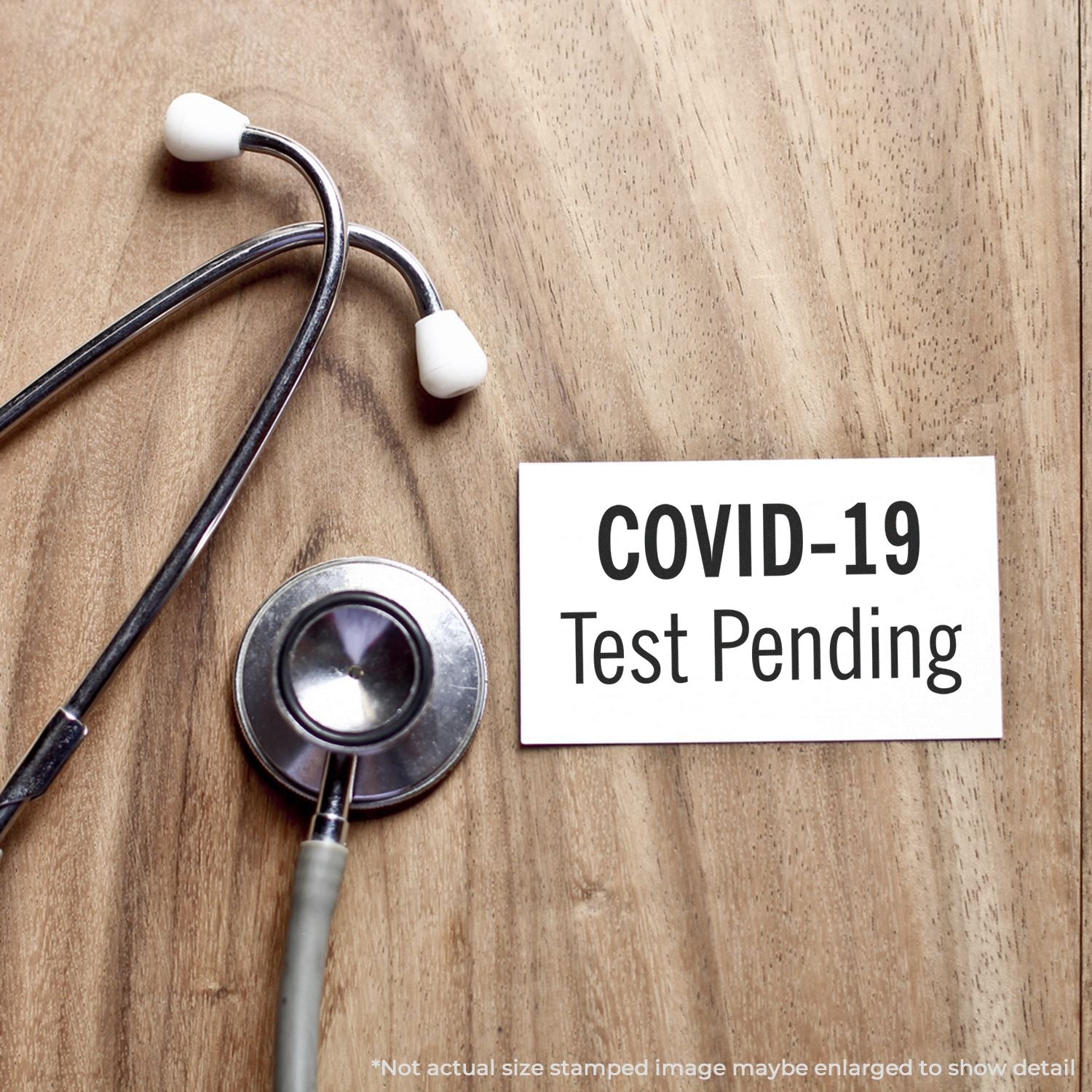 Stethoscope beside a COVID-19 test pending notice on a wooden background, indicating medical coronavirus screening results status.