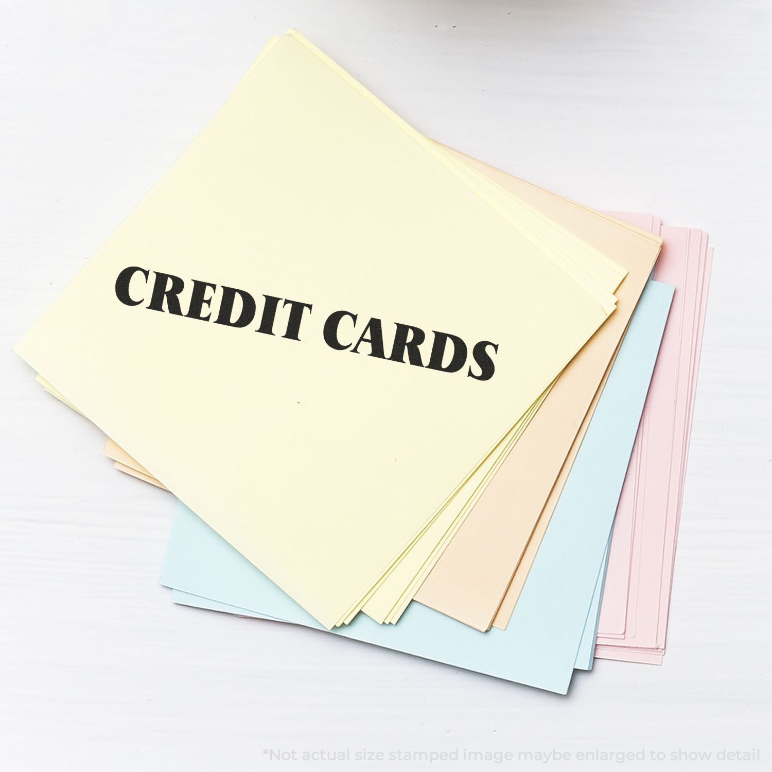 Stack of pastel cardstock sheets labeled CREDIT CARDS, ideal for DIY printable credit card design and crafting.