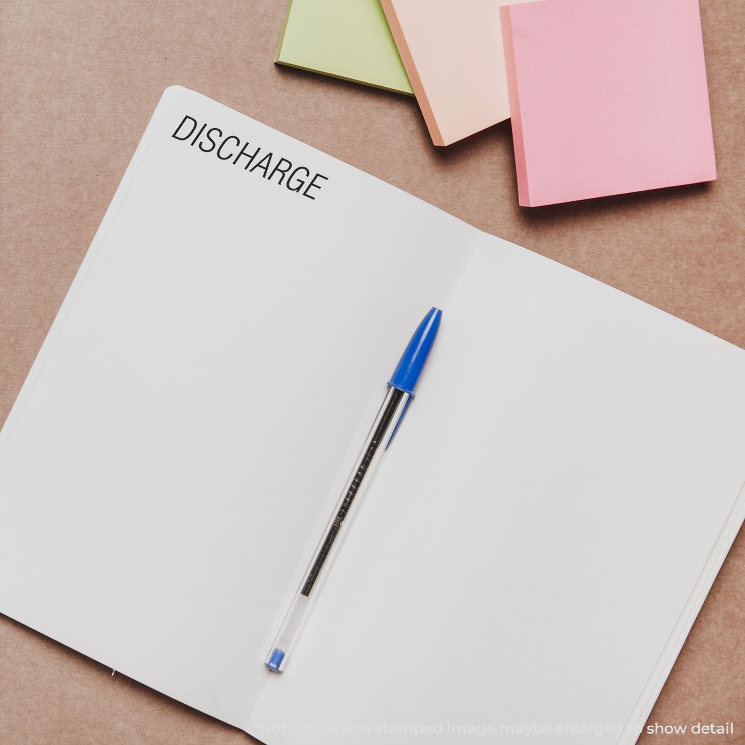 Notebook page labeled DISCHARGE with pen and colorful stationery, illustrating medical discharge paperwork preparation.