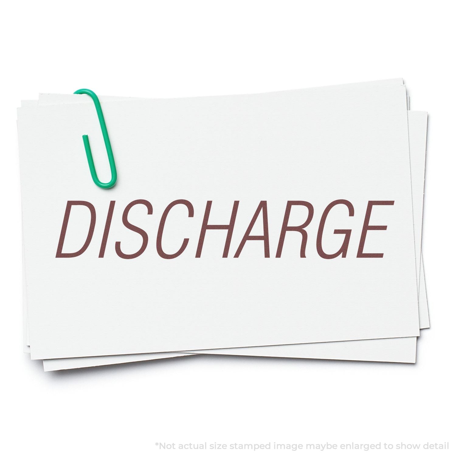 White discharge paperwork folder with green paperclip labeled DISCHARGE, representing patient release documents for hospital discharge process.