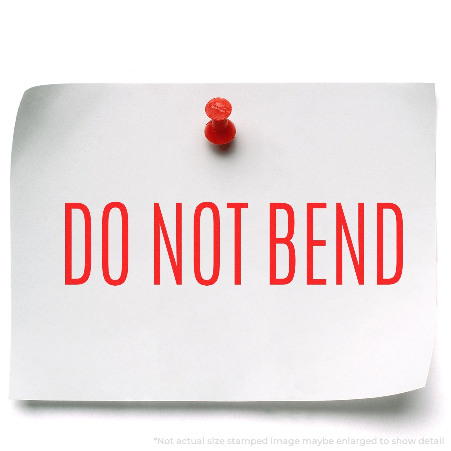 Close-up of a pinned DO NOT BEND warning note on packaging, showing fragile shipping handling instruction.