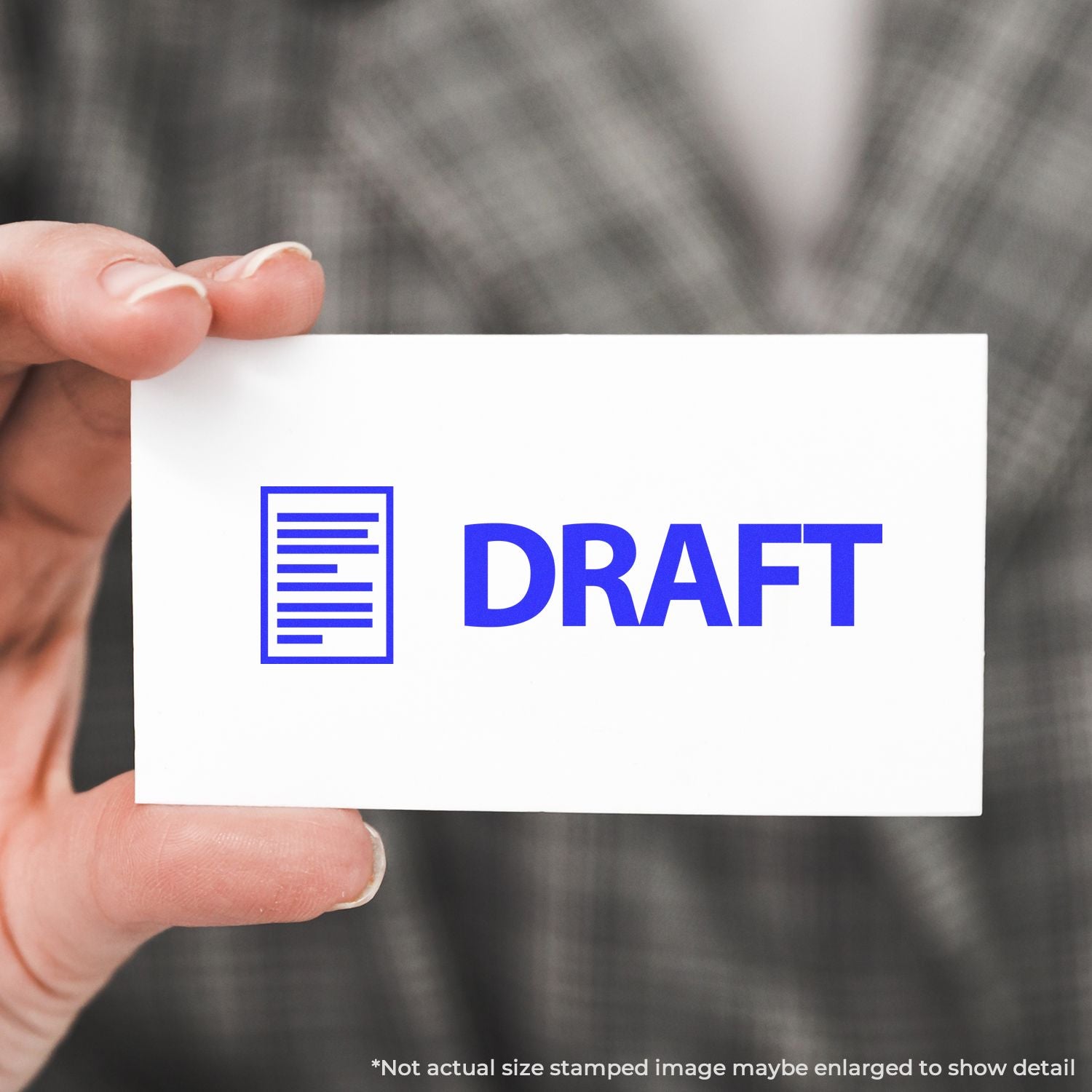 Hand holding a white document card marked DRAFT, symbolizing a work-in-progress copy for document review and editing.