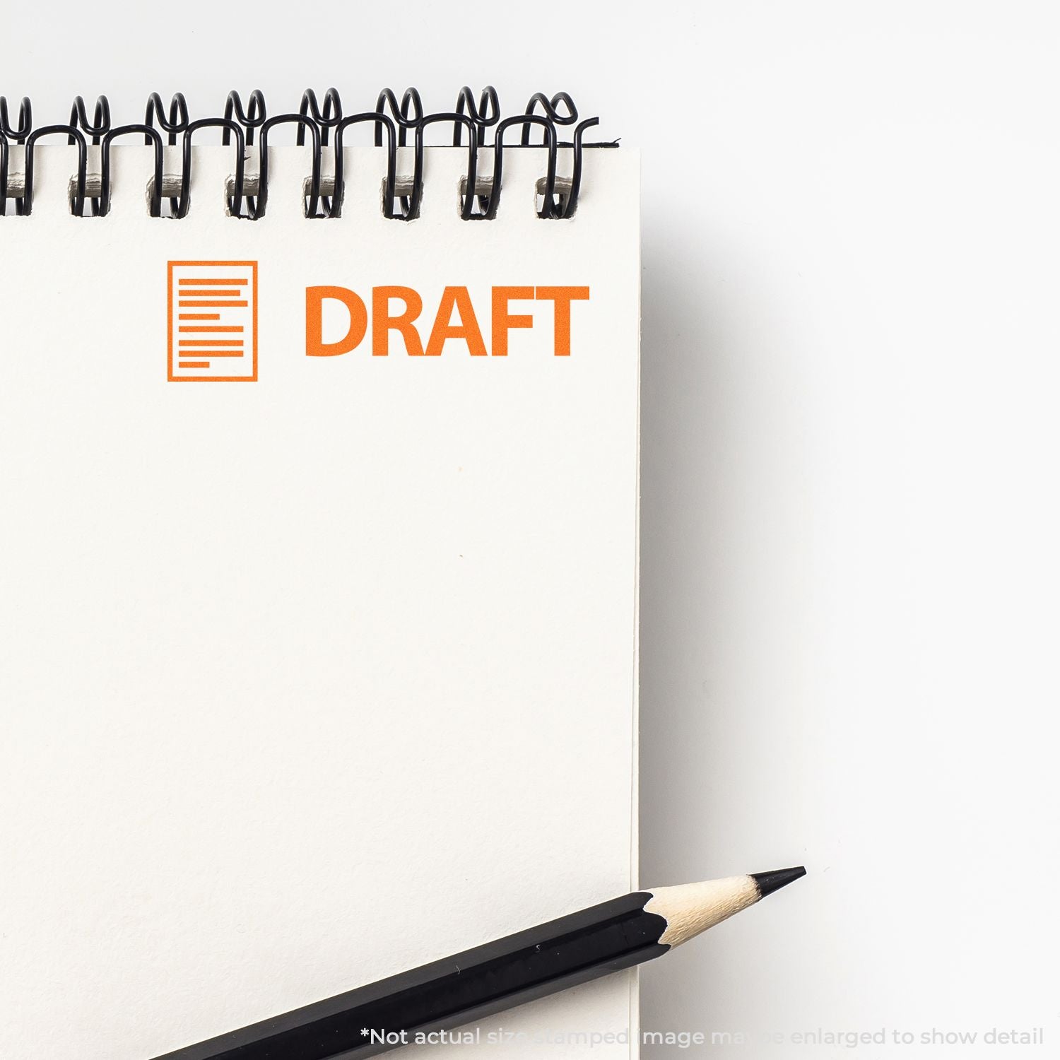 Spiral notebook with orange draft stamp and pencil, blank document concept on white background