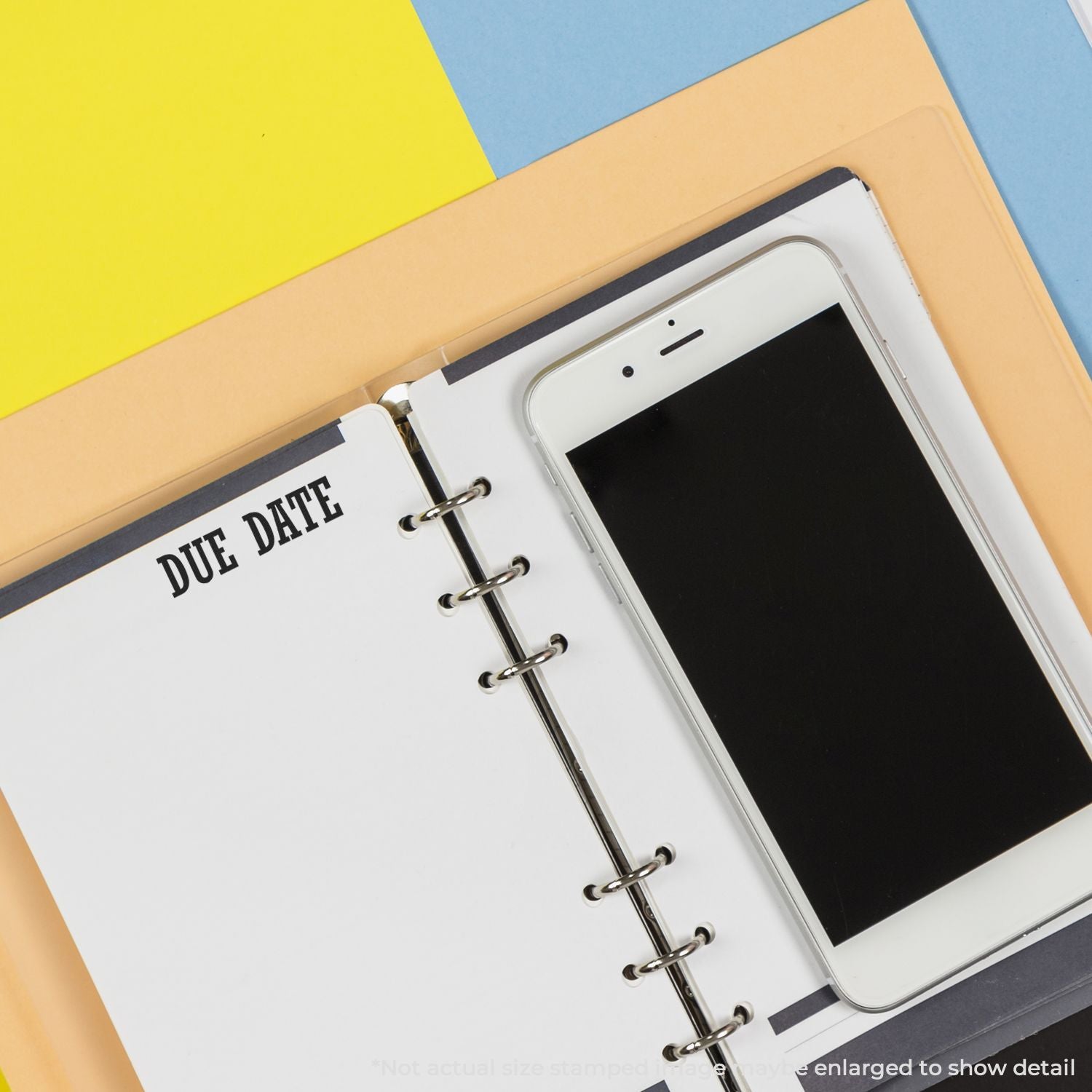 Planner with Due Date tab and smartphone showing deadline reminder for scheduling tasks, work projects, and staying organized.