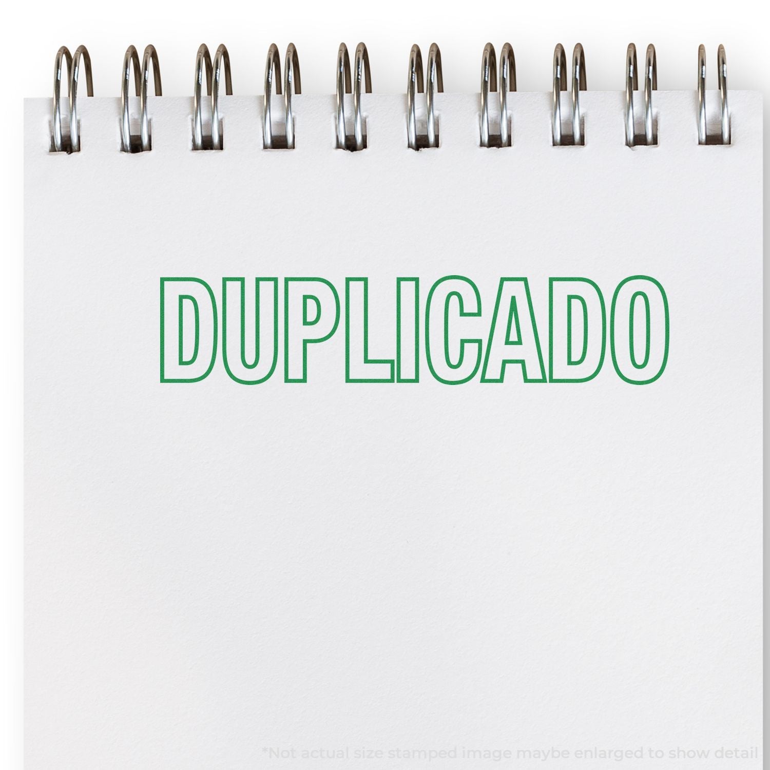 Spiral notebook page with DUPLICADO in green text, representing a duplicate document or copy.
