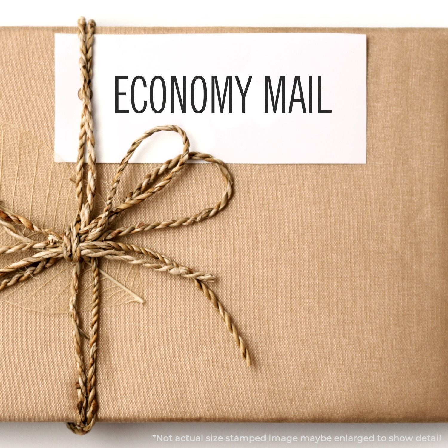 Economy mail package tied with twine, showing ECONOMY MAIL label for affordable shipping and delivery.