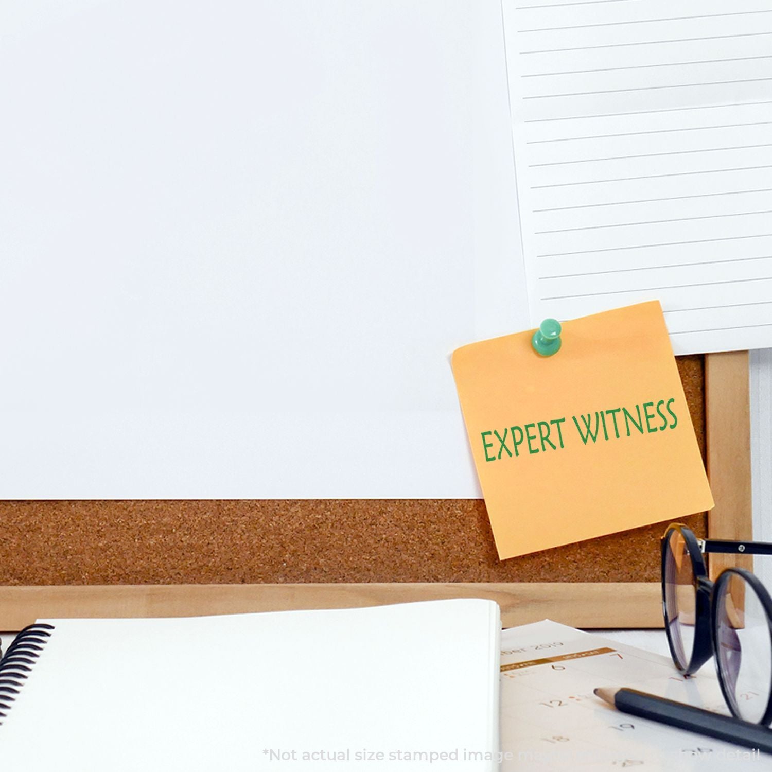 Sticky note reading Expert Witness pinned to corkboard above office desk, highlighting expert witness testimony and legal support services.