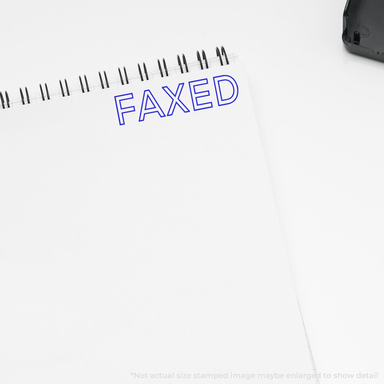 Notepad with blue FAXED stamp showing confirmed document faxing and sending status for business records.