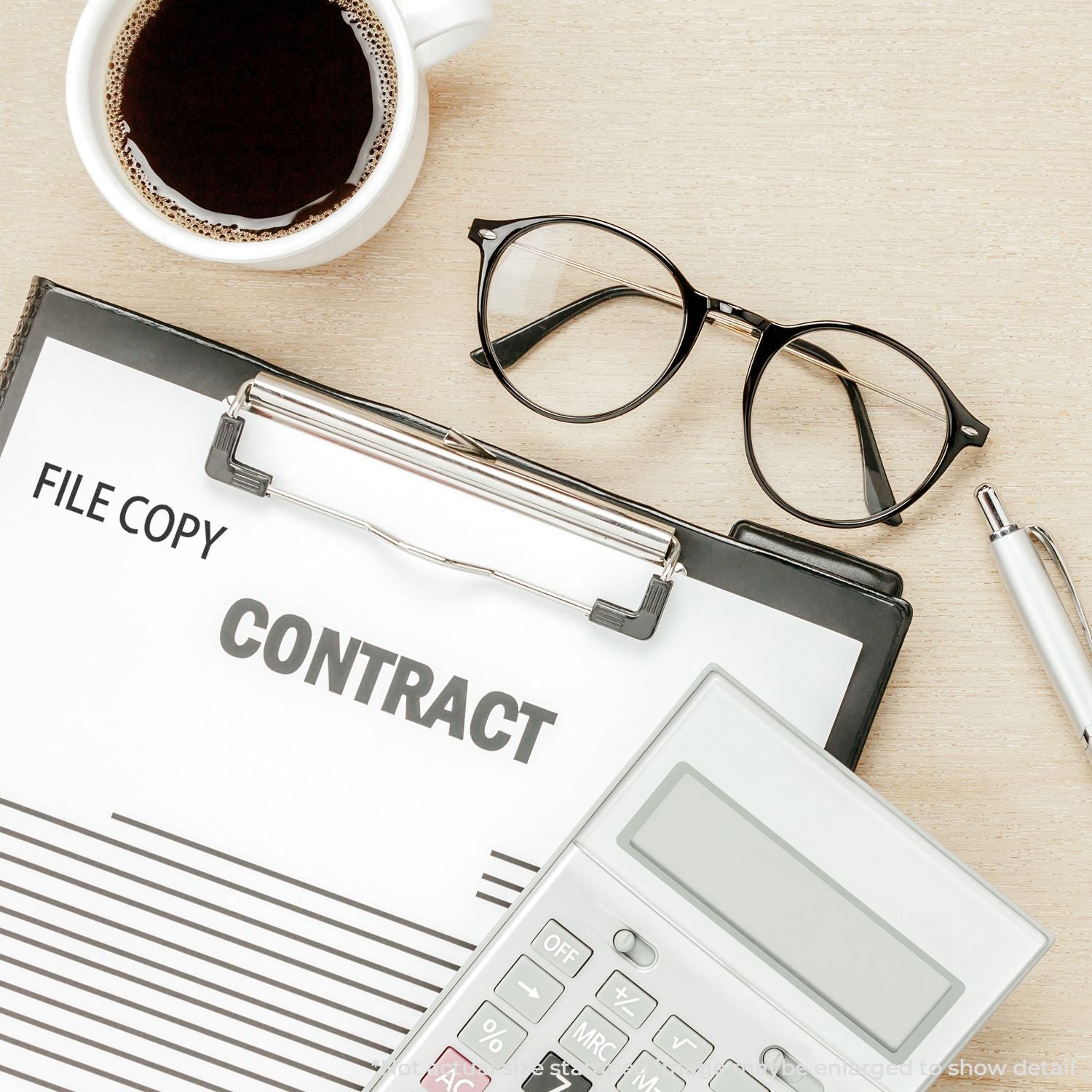 File copy contract on desk with eyeglasses, calculator, pen, and coffeeillustrating document preparation and legal paperwork