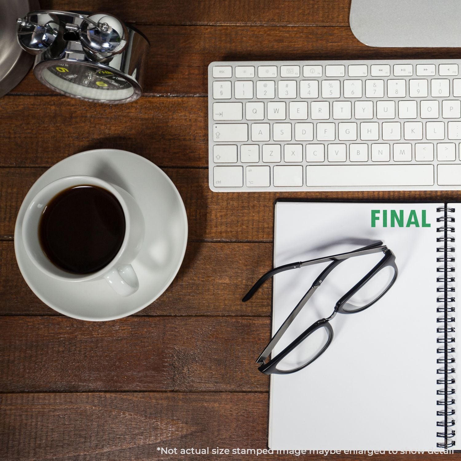 Top view of laptop keyboard, coffee, and FINAL notebook with glasses, showcasing productivity and deadline planning.