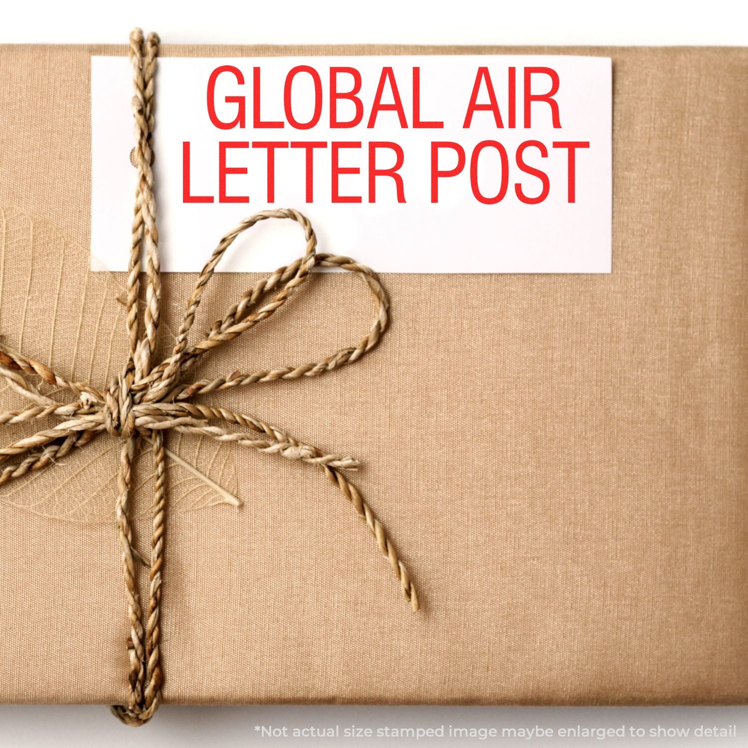 Global Air Letter Post shipping label on a tied kraft package, showing international mail transport services.