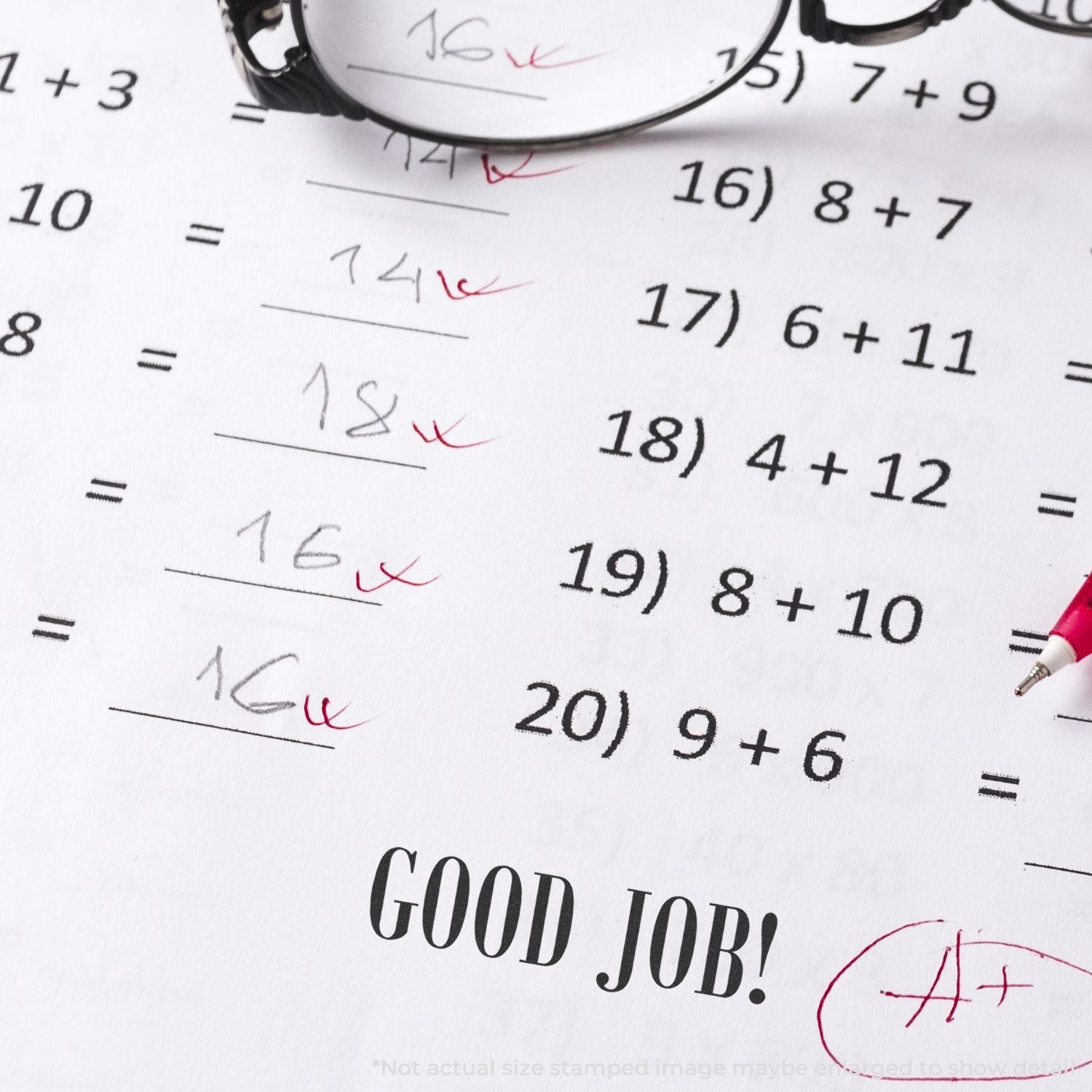 Math worksheet with addition problems, red-ink corrections, glasses, and a Good Job! grade mark.