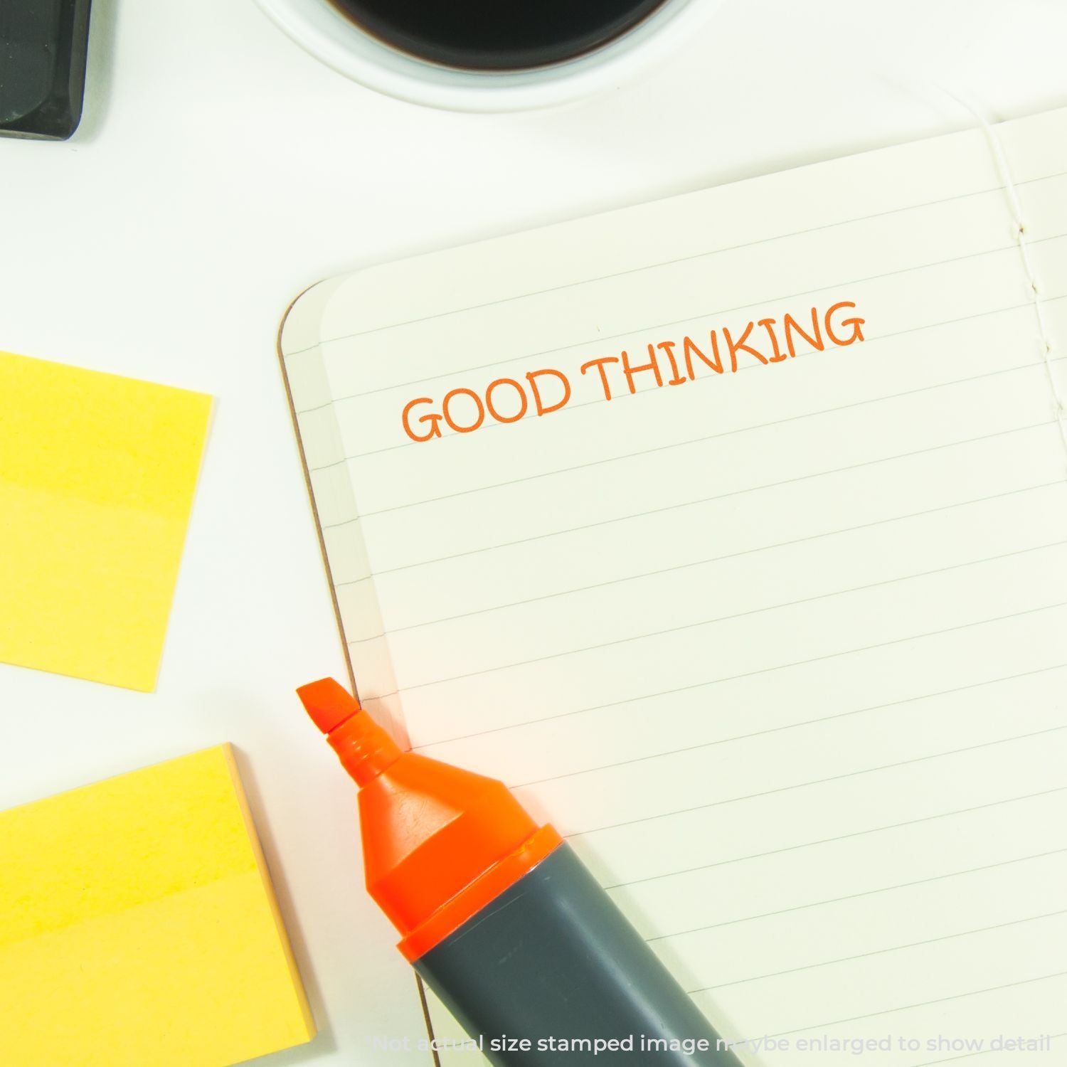 Notebook page with Good Thinking written in orange marker, promoting a positive mindset and productive ideas.