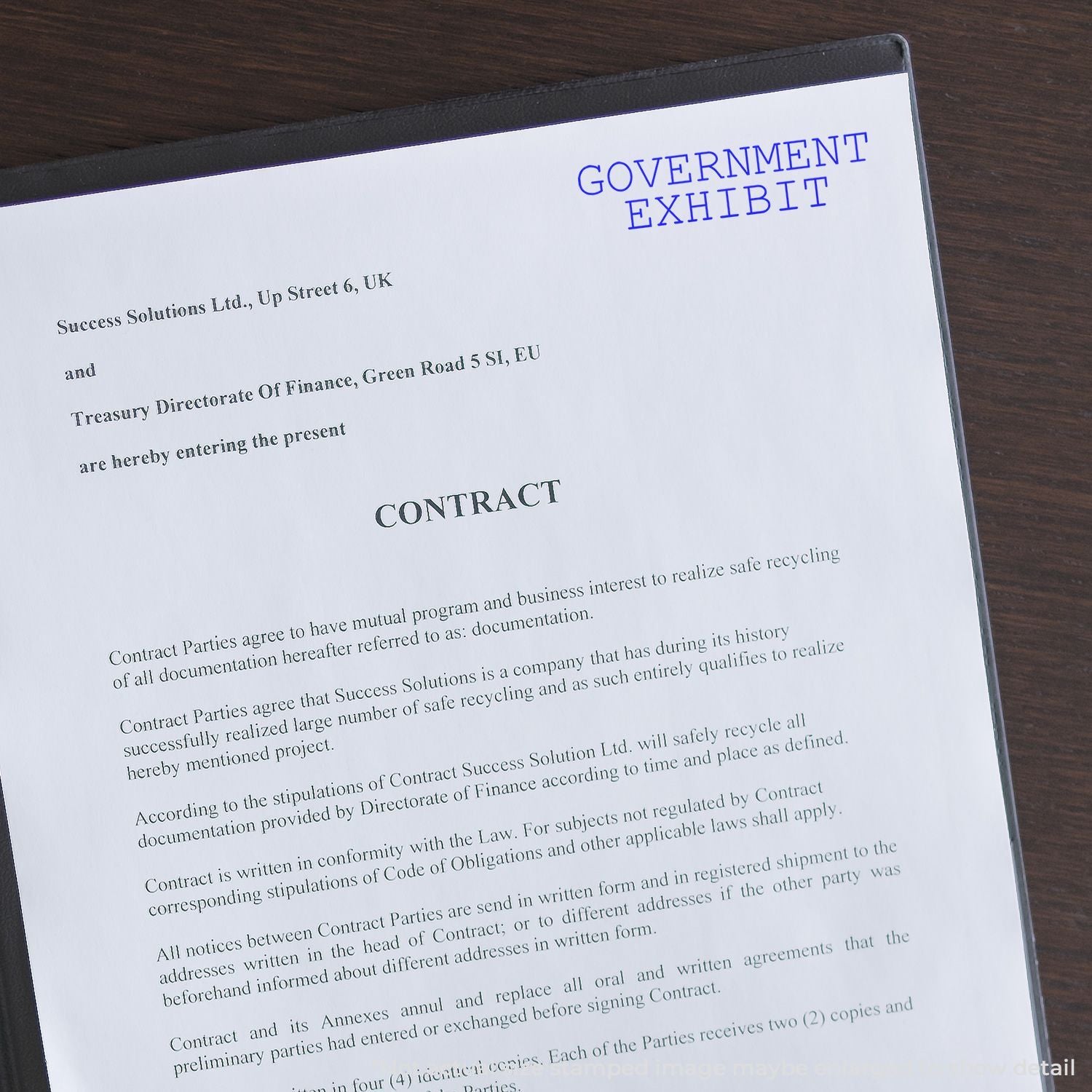 Government exhibit contract document on a desk with official legal text and finance department header.