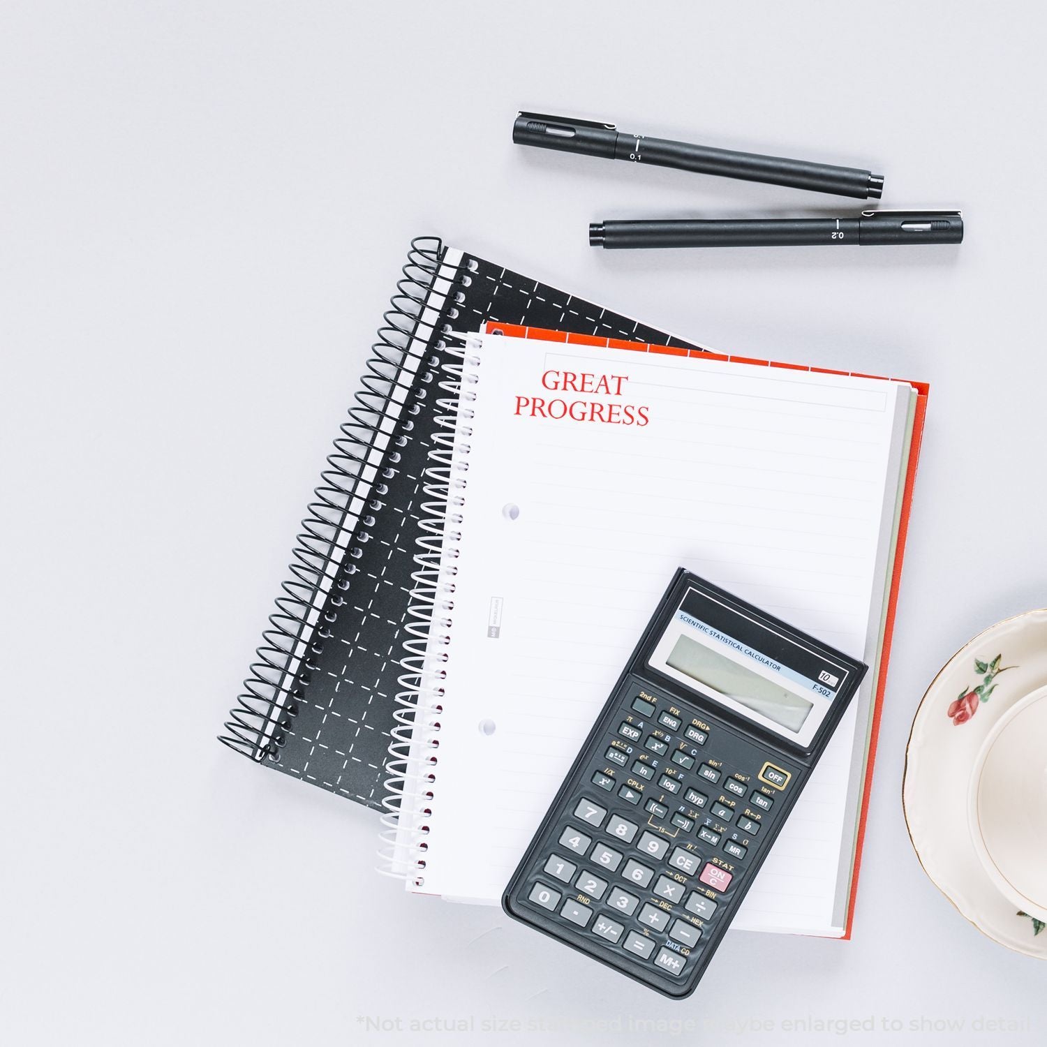 Great Progress notebook with scientific calculator and pens on desk, illustrating study planning and math productivity.