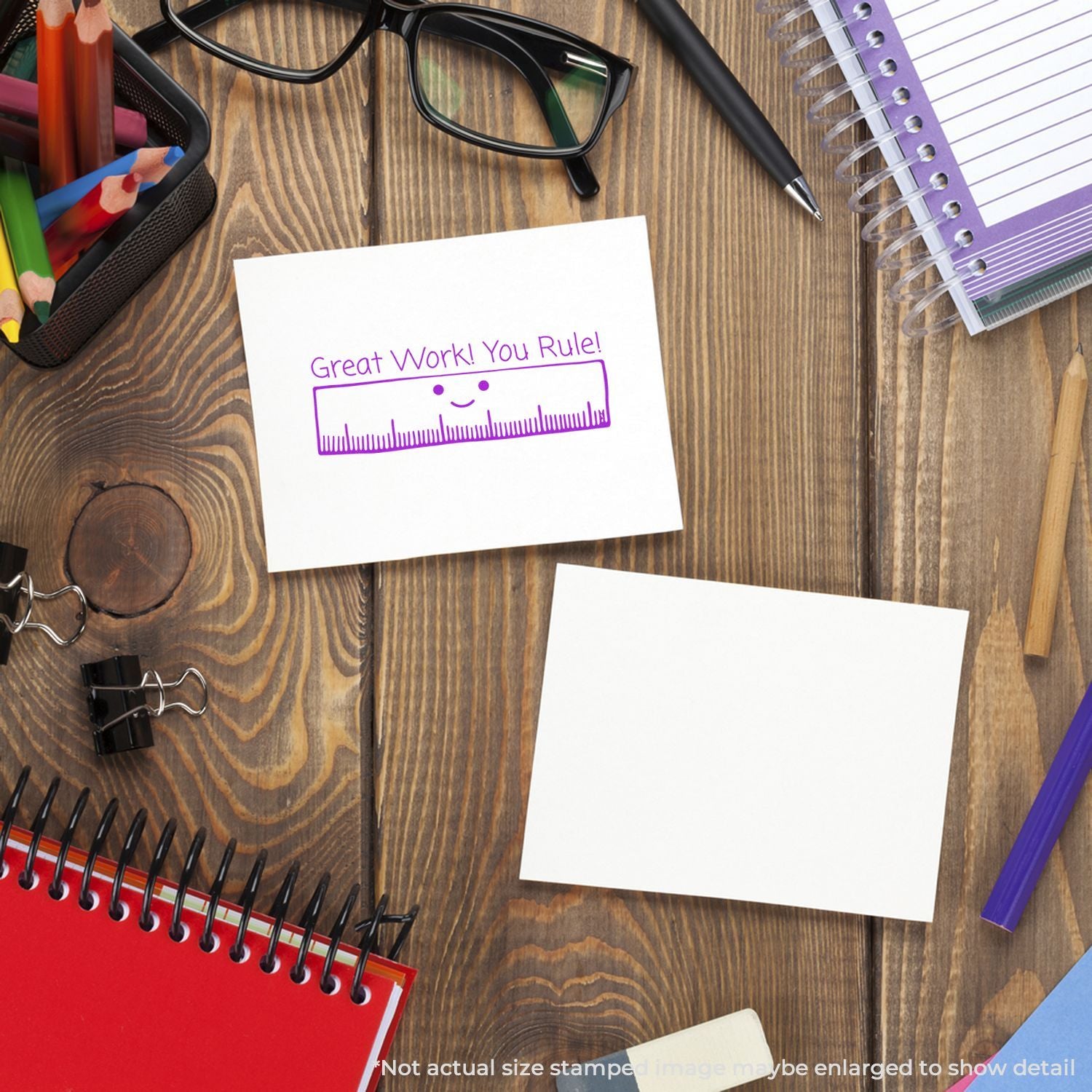 School desk with stationery, glasses, notebooks, and a sticky note reading Great Work! You Rule!