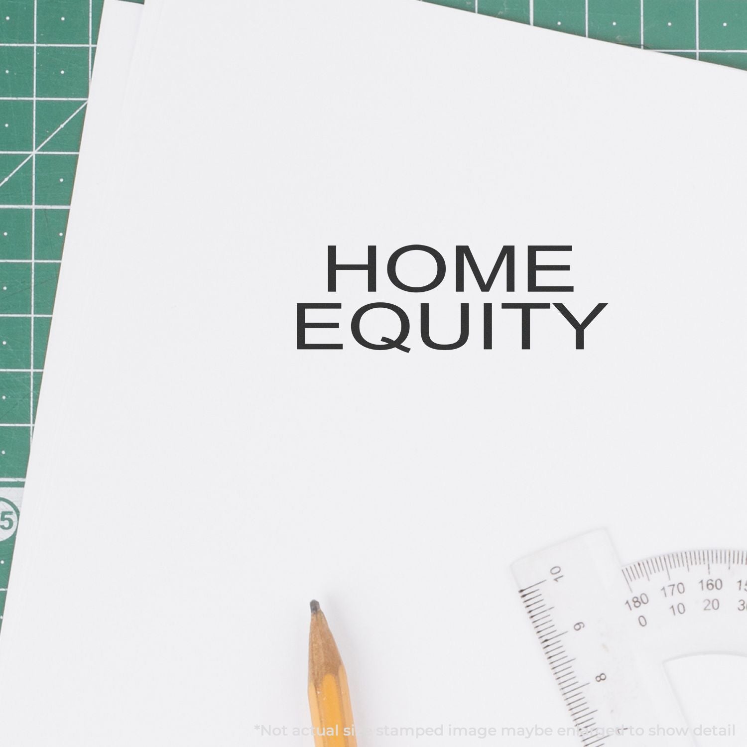 Crafting materials on a cutting mat showing the 'Home Equity' title design for a real estate finance workshop brochure template.