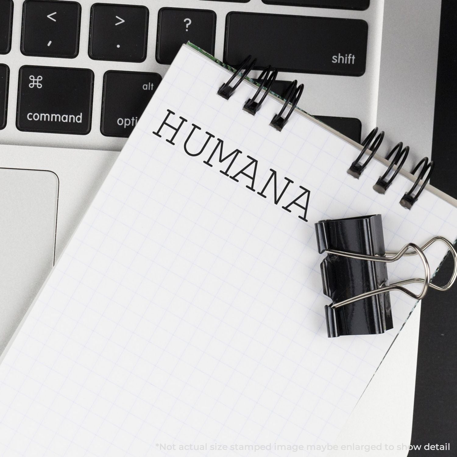 Notebook planner stamped HUMAN on computer keyboard, symbolizing human-centered productivity and HR planning