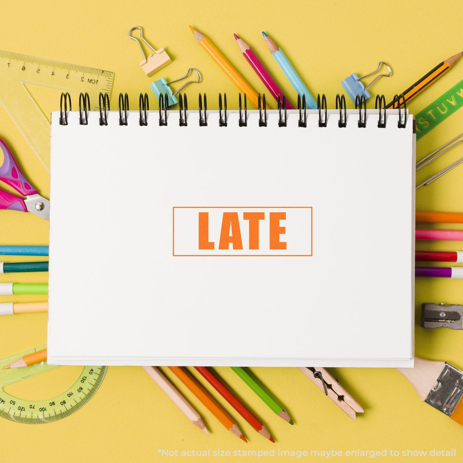 LATE printed on blank notebook with colorful pencils, pens, ruler, and clipsback-to-school education supplies background.