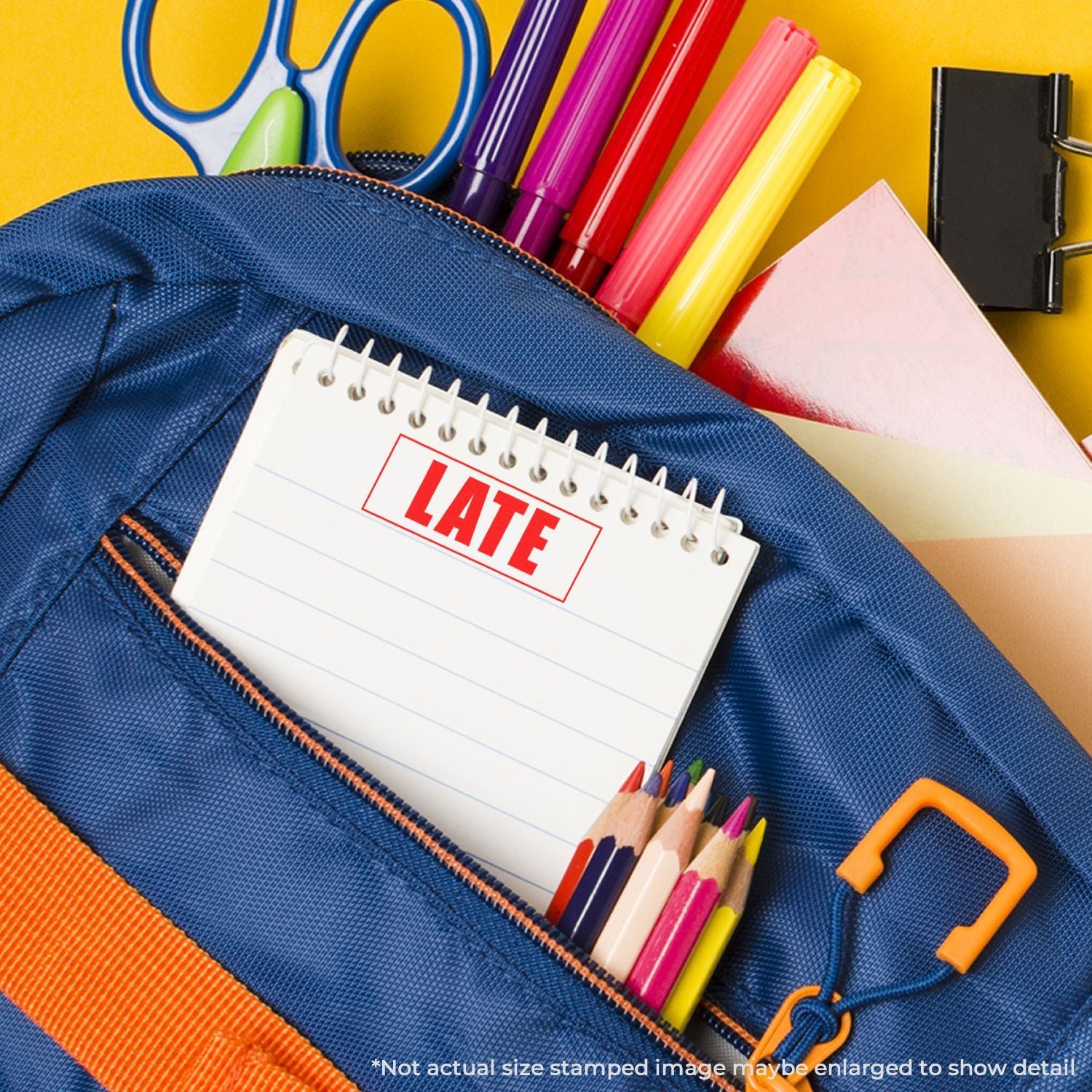 Blue school backpack with late stamp notebook, colorful pens, pencils, scissors, and office supplies on a yellow background for back-to-school concept