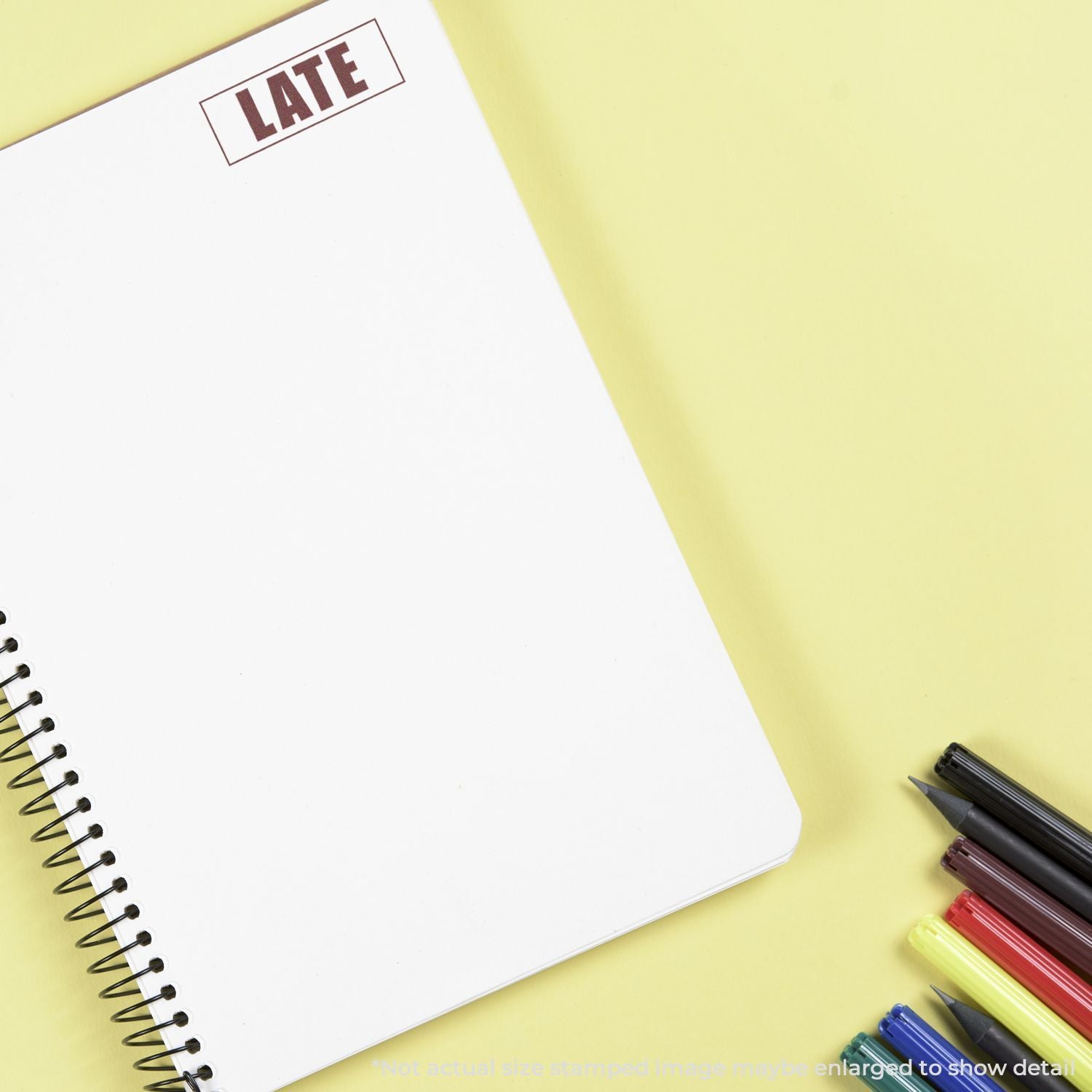 Late reminder note on blank spiral notebook with pencils, highlighting urgency for time management and missed deadlines.