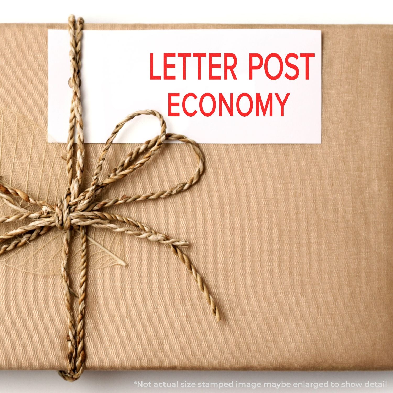 Kraft paper parcel wrapped with twine and label reading Letter Post Economy for eco-friendly postal delivery.