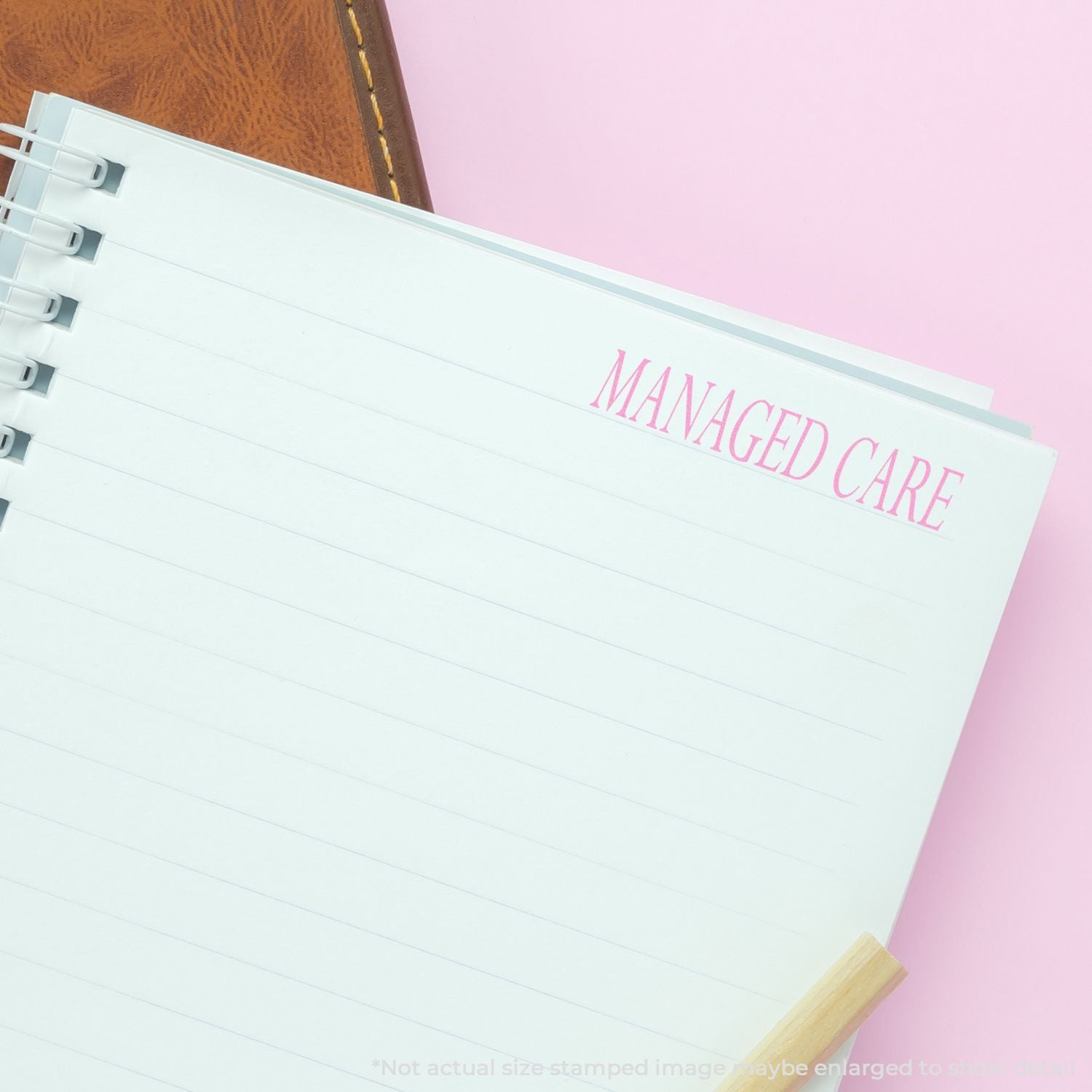 Notebook titled Managed Care for documenting healthcare coverage and managed care notes on a pink desk.