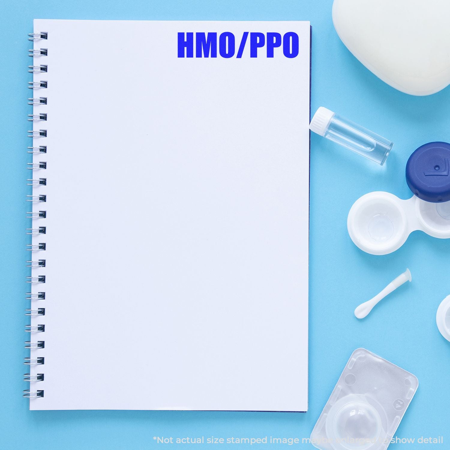HMO PPO health insurance comparison concept: blank spiral notebook with medical supplies for benefits planning