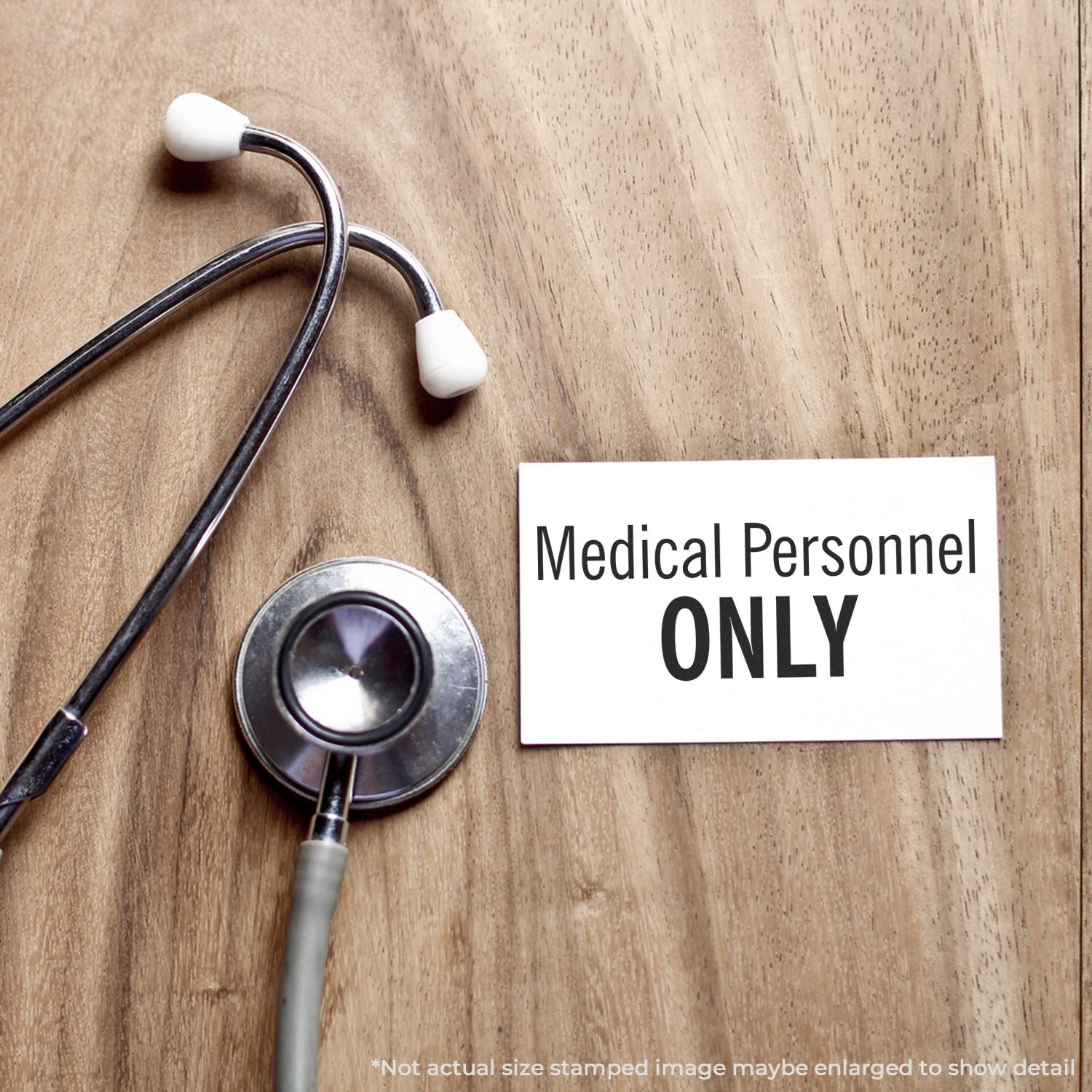 Stethoscope beside Medical Personnel ONLY sign, highlighting limited access for healthcare staff on wooden surface.
