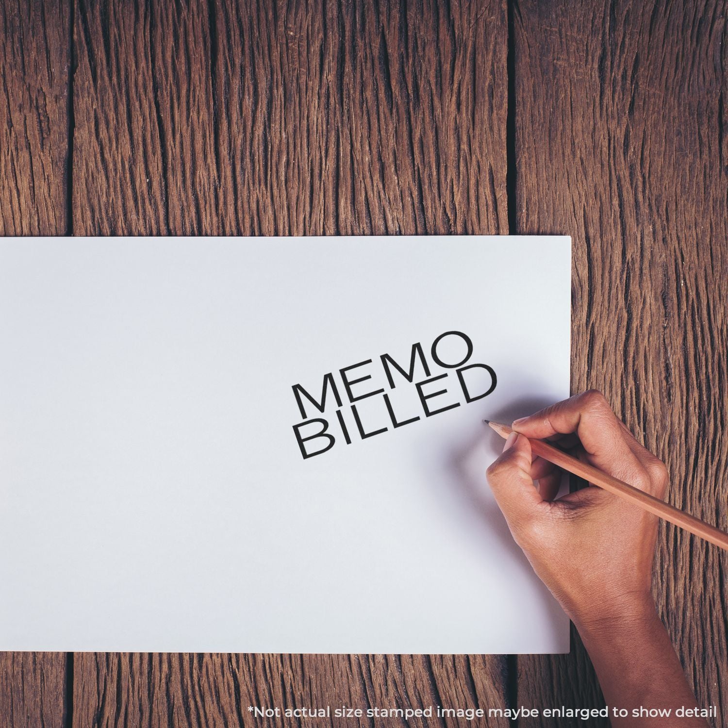 Hand writing Memo Billed on white paper on a wooden desk, concept of billing, invoicing, and business accounting.