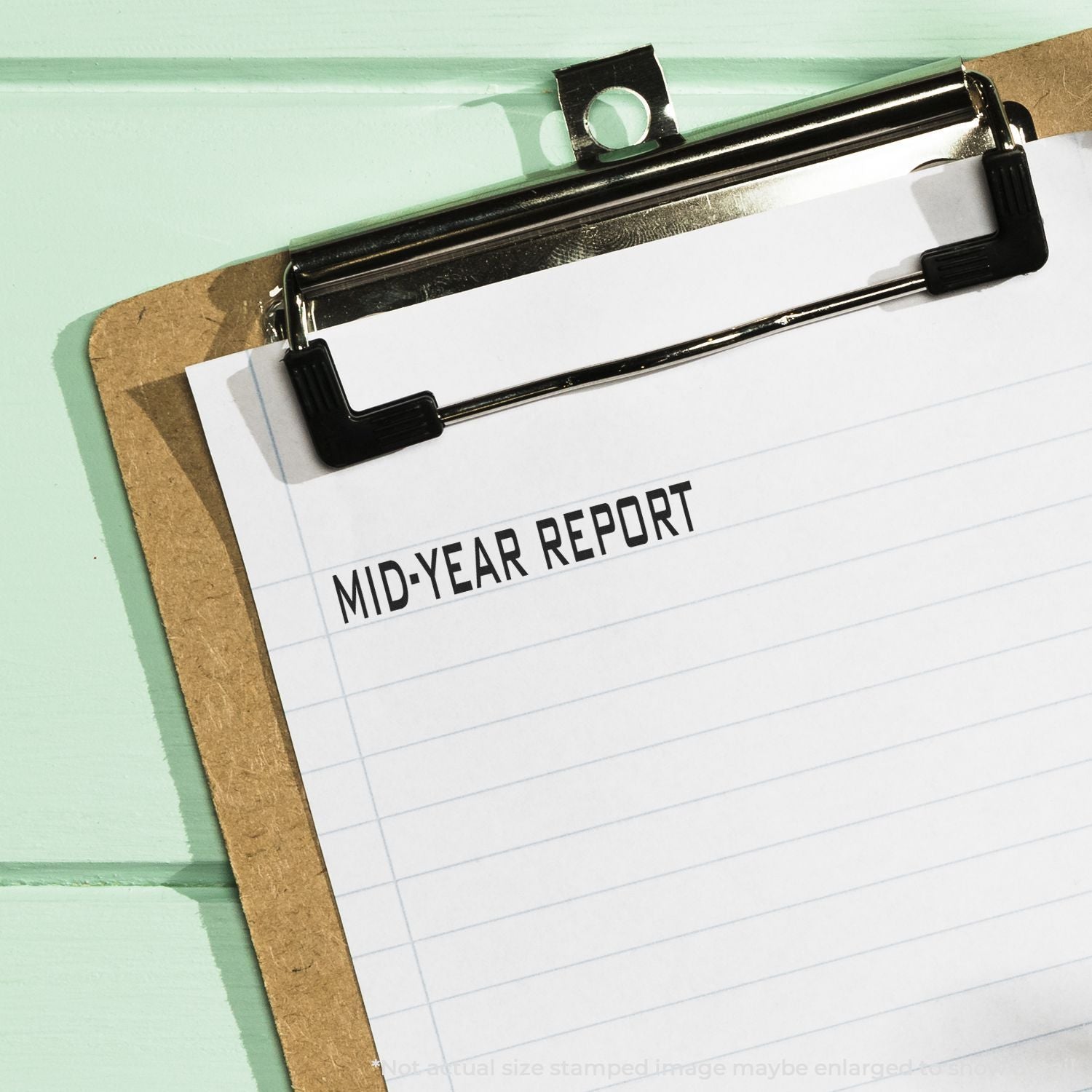 Clipboard with blank mid-year report form on mint green background, business and finance document concept